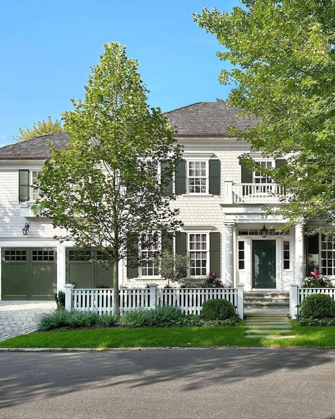 A home that transports you to a place where time moves a little slower.

In a classic Colonial Revival, the beauty is in simplicity and proportion. A forest green door and shutters borrow their palette from the surrounding landscape, while a columned