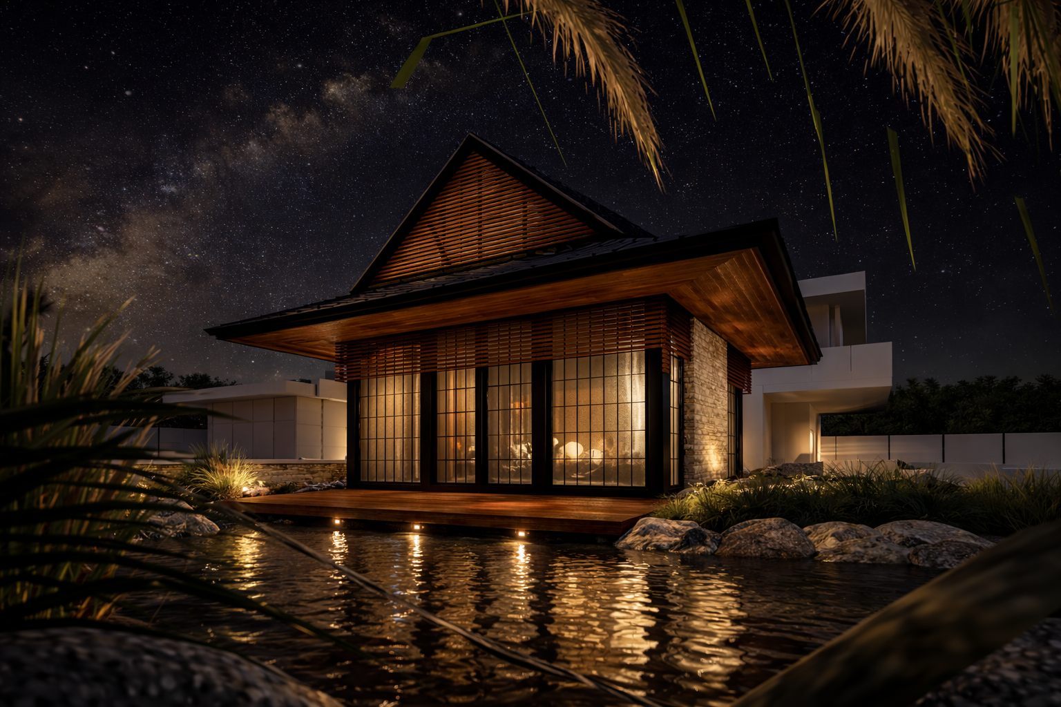 A modern house illuminated at night, with large glass doors and a wooden deck, surrounded by rocks and plants, under a starry sky with the Milky Way visible.