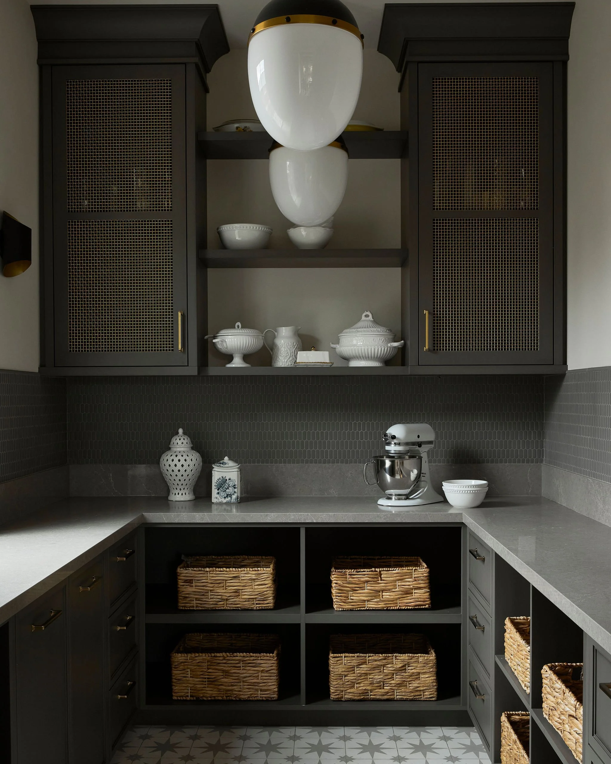 Luxury modern two-story home in Oakville by architecture firm, featuring dark exterior, large windows, landscaped lawn and refined outdoor lighting at dusk