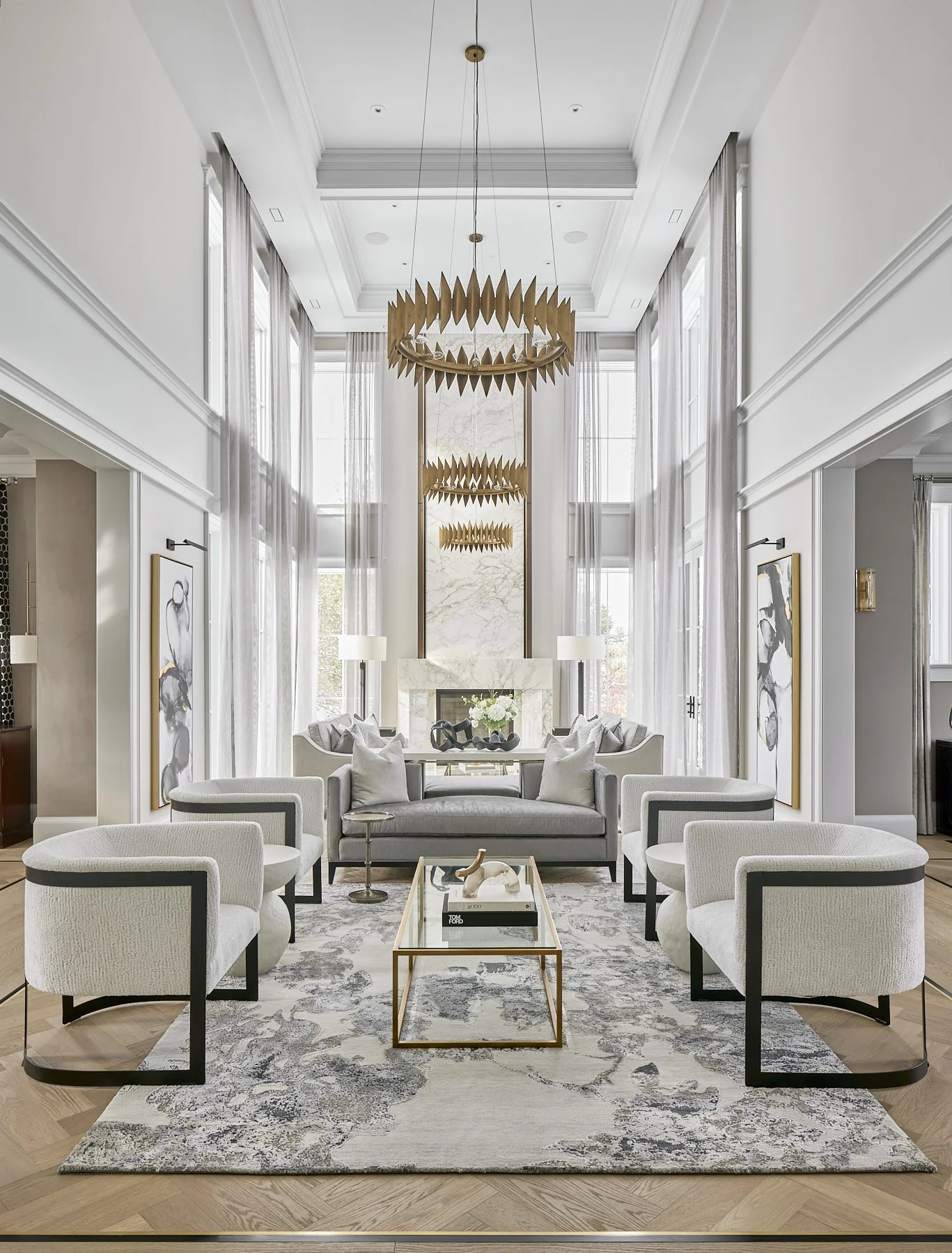 Luxury living room in Oakville custom home by architecture firm, featuring high ceilings, large windows, marble fireplace and refined contemporary furnishings