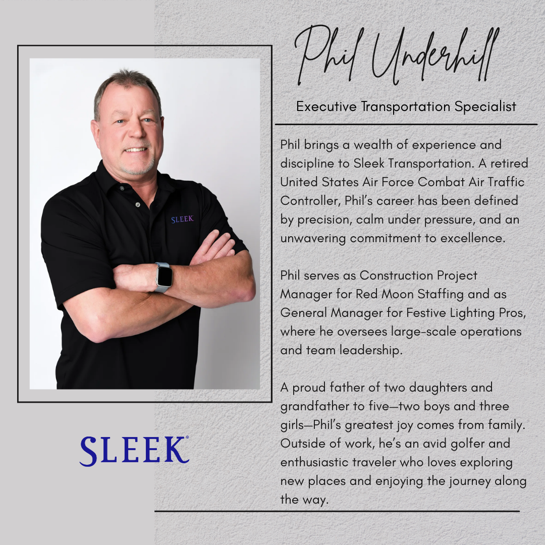 A middle-aged man with short gray hair and a goatee, smiling and crossing his arms, wearing a black polo shirt with the word 'SLEEK' embroidered on it and a smartwatch on his left wrist, standing against a plain white background.