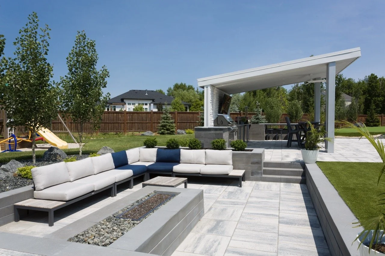 Outdoor patio with modern furniture, a fire pit, pergola, barbecue area, and playground slide on grass