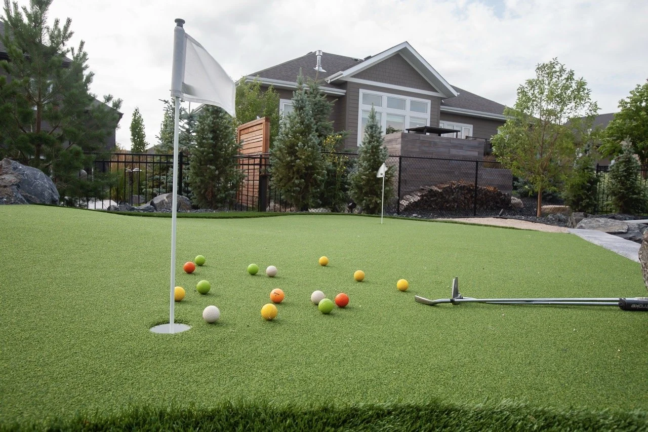 Backyard putting green with golf balls and flags