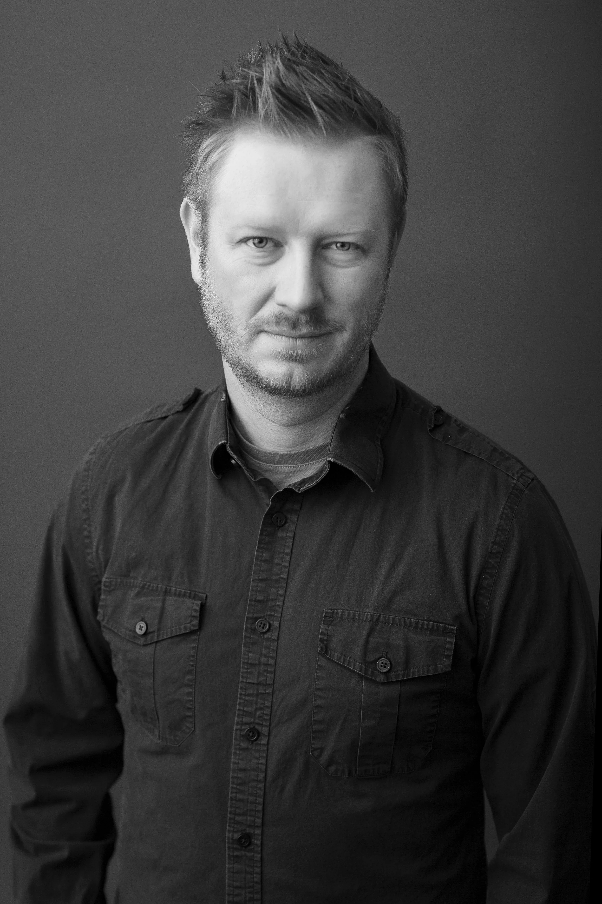 black and white image of man looking at camera