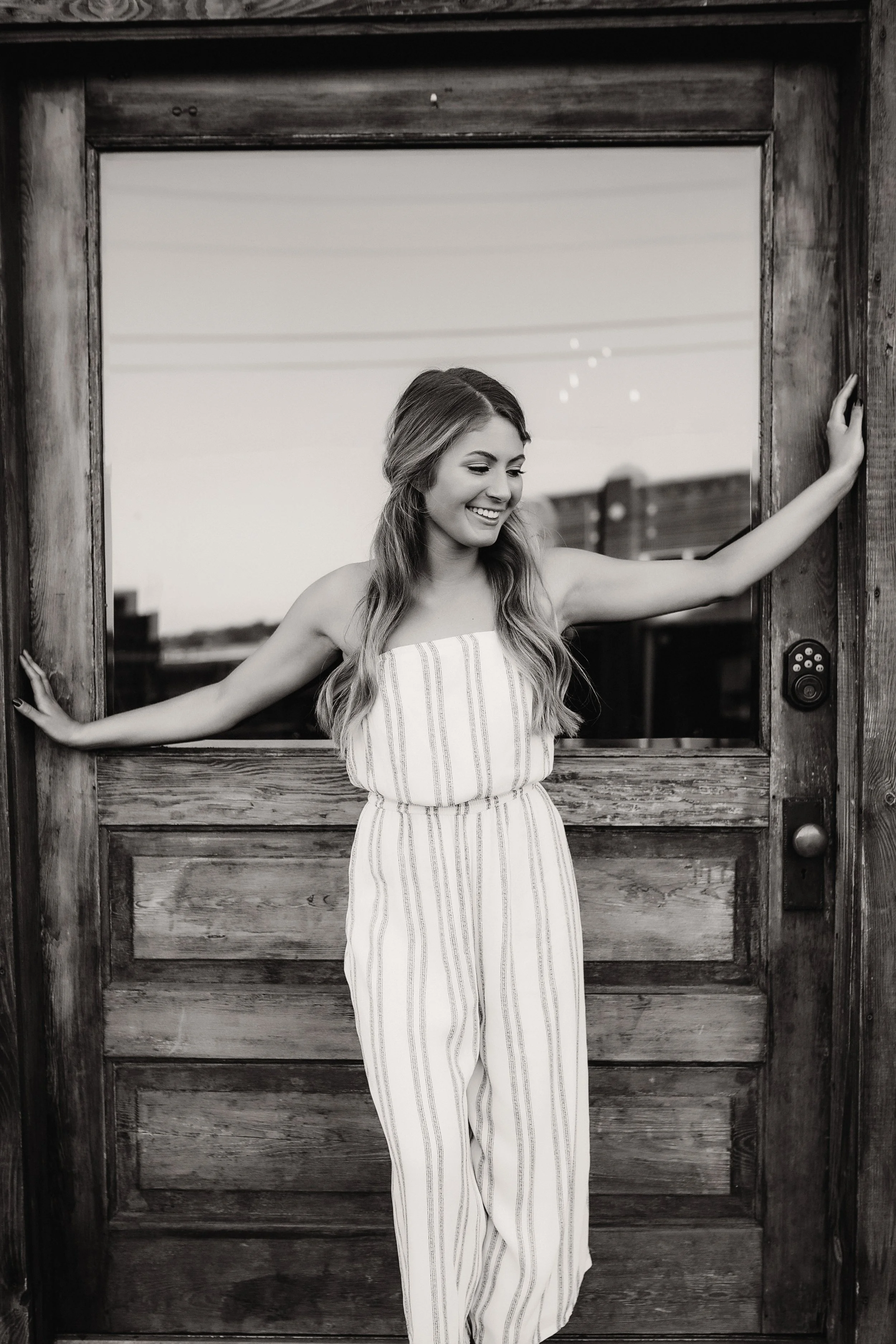 smiling teenage girl standing in doorway
