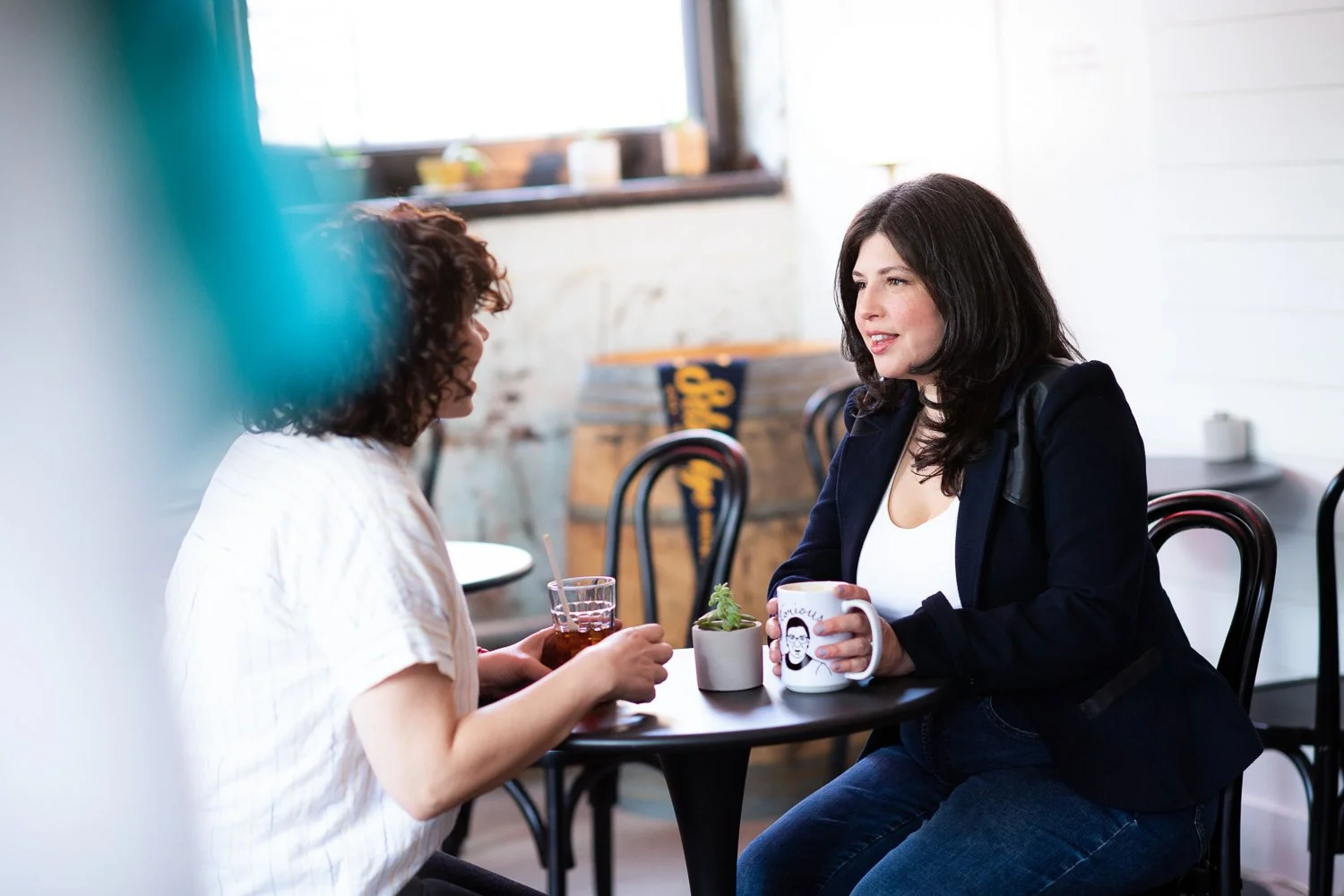 Maypop Creative Studio website redesign services expert Carolyn Leasure having coffee with a client
