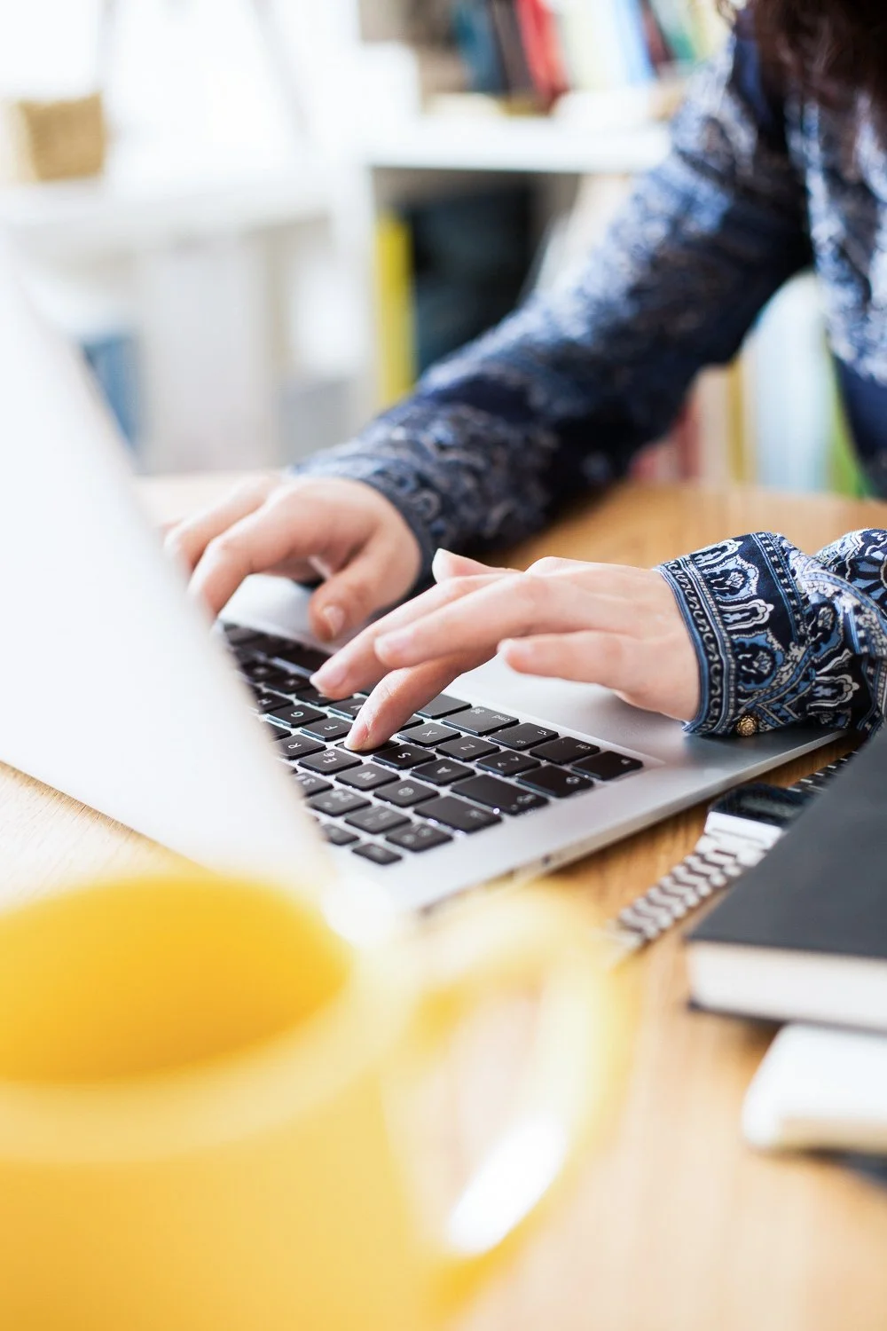 Maypop Creative Studio website redesign services expert Carolyn Leasure working on a laptop
