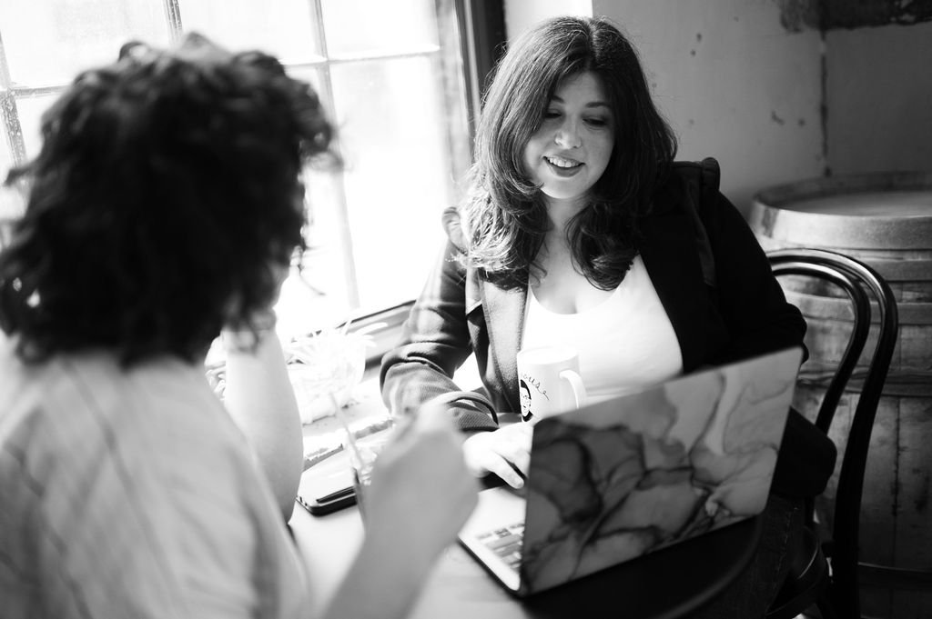 Maypop Creative Studio website redesign services expert showing a client their website redesign on a laptop