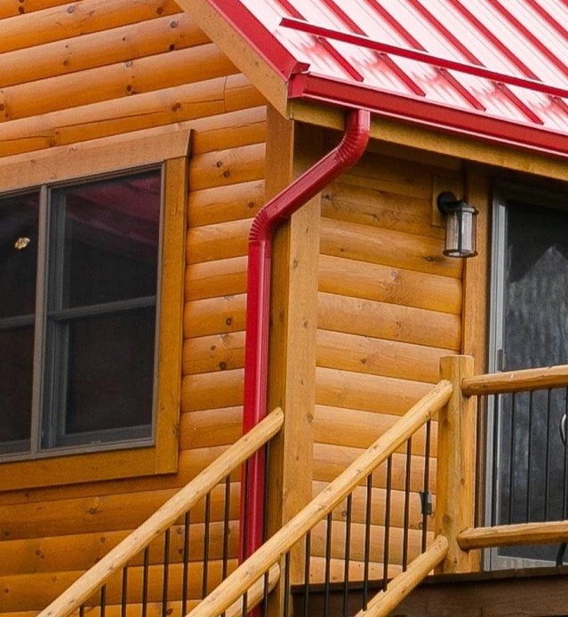 Log Corner Post with D Logs -
Log Home with Red Metal Roof
