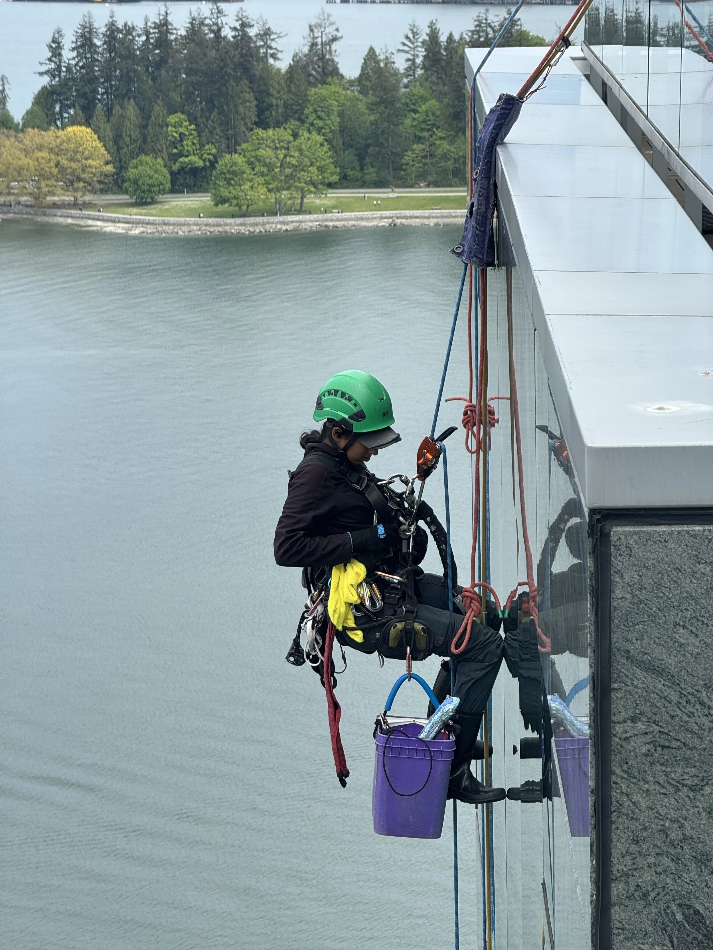 Rope access window cleaning on glass curtain wall high-rise Vancouver