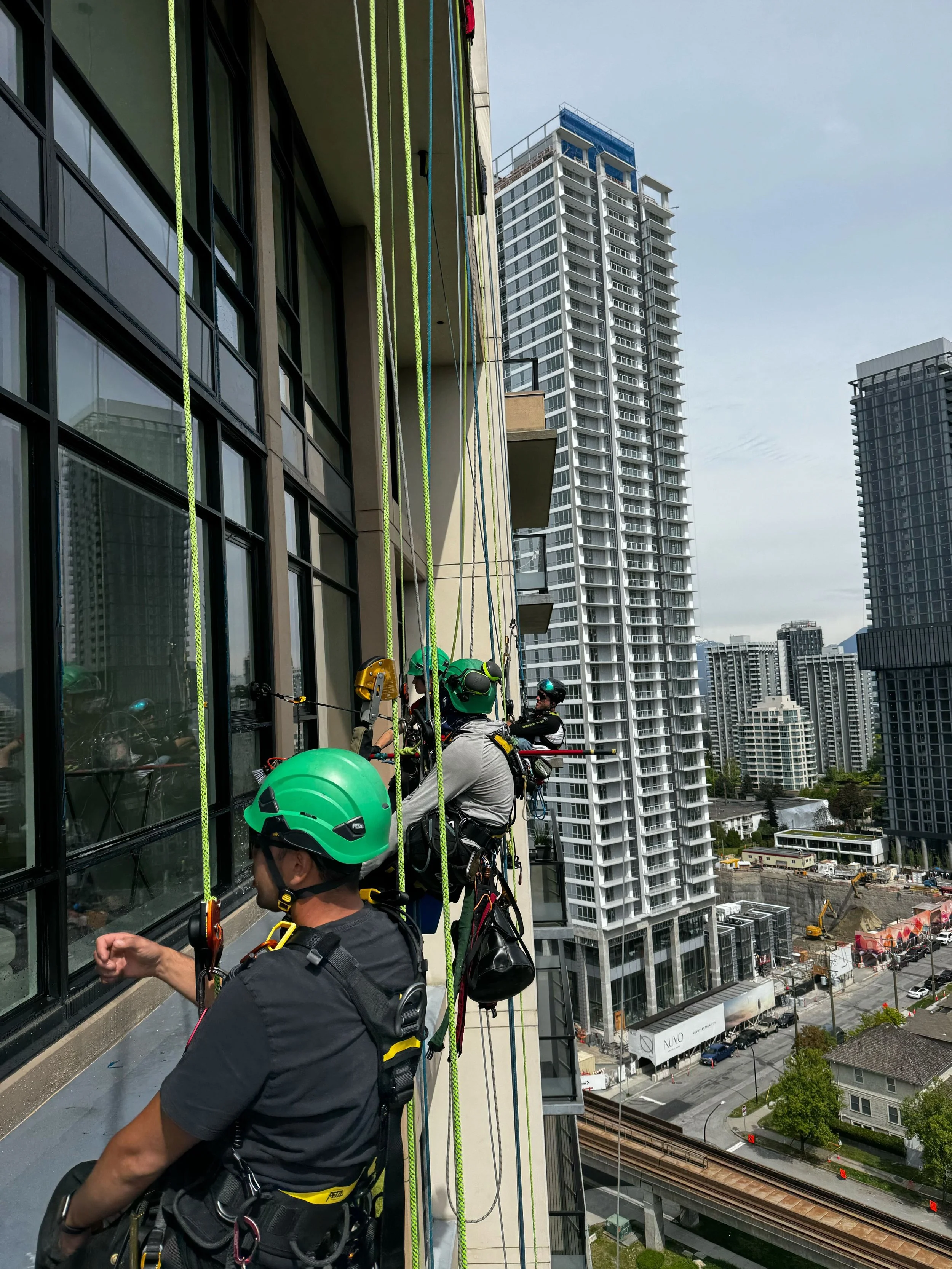 Professional rope access team performing building maintenance Richmond BC