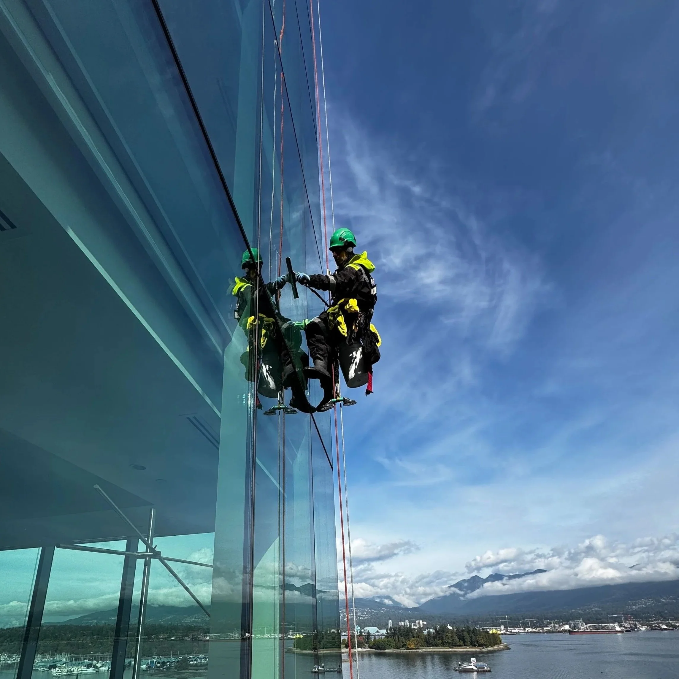 IRATA certified rope access technician cleaning high-rise windows Vancouver