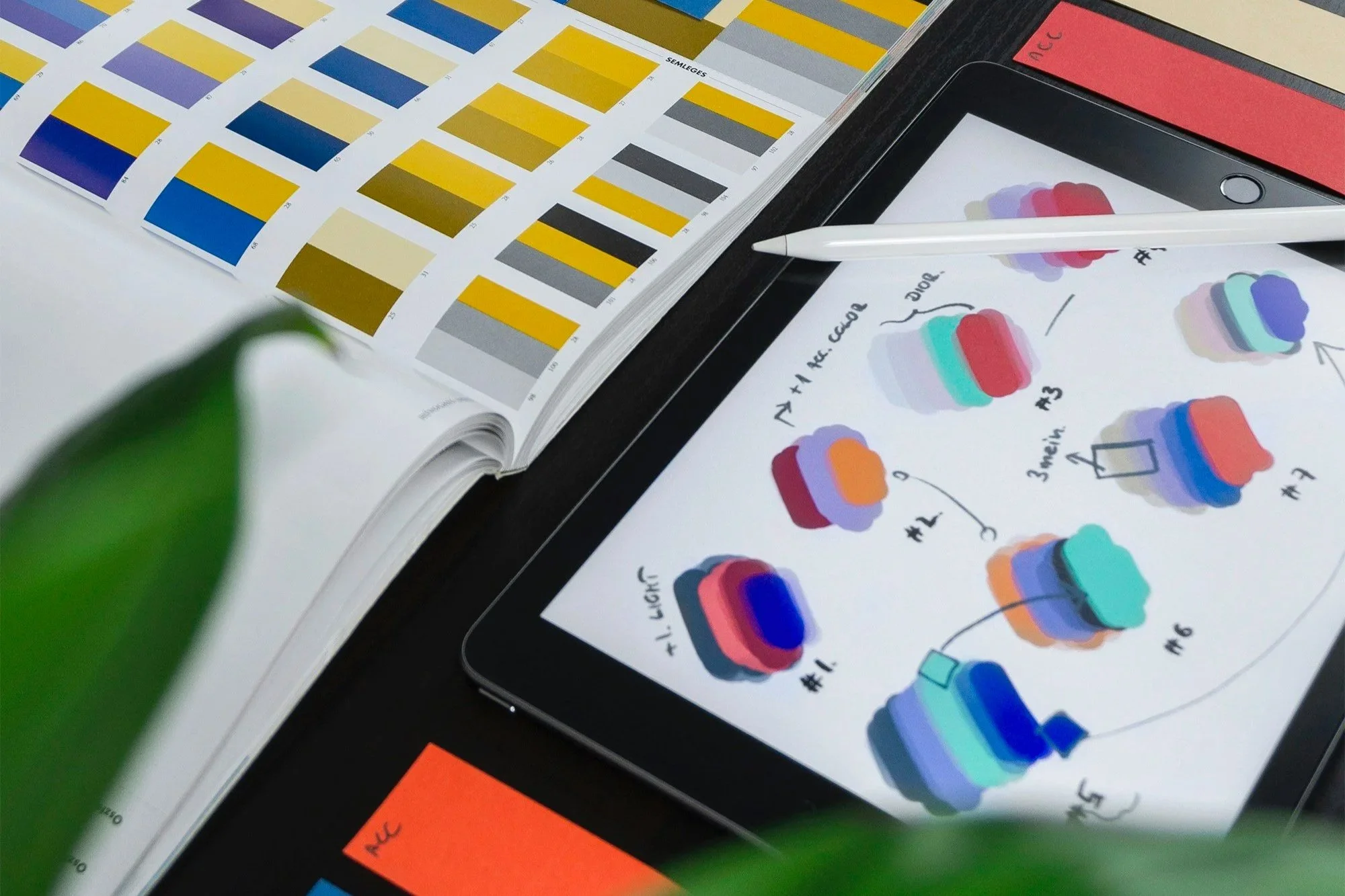 Closeup of color swatch book and iPad display of color combinations