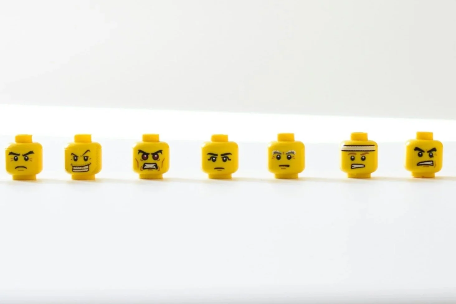 Yellow lego heads with frowning faces