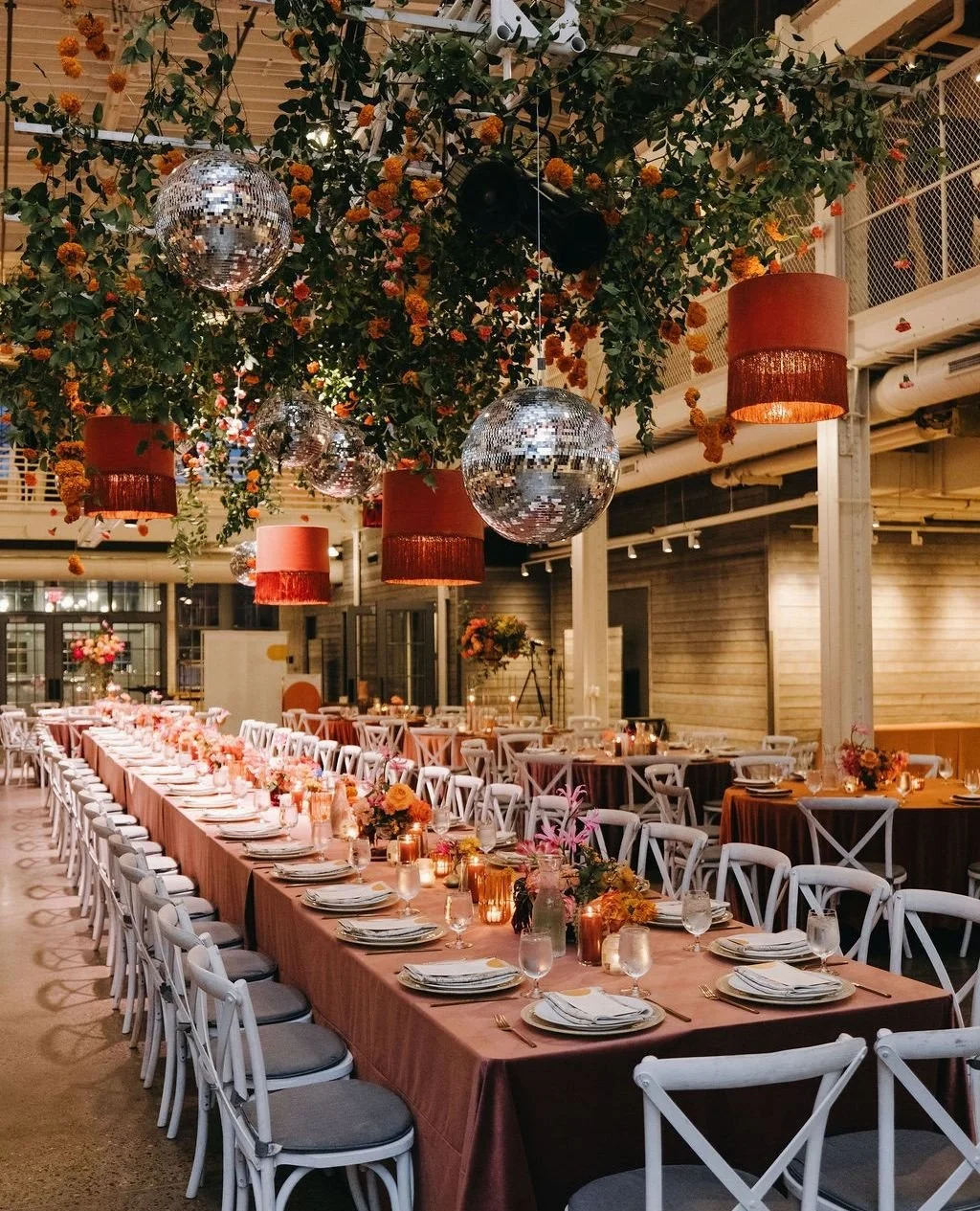 Fringe pendants and disco balls add a playful touch to this autumn wedding.⁠
⁠
Planning | ⁠@stylearchitectsweddings⁠
Venue | @machineshopmpls⁠
Catering | @indiapalacemn⁠
Staffing | @hostatoast⁠
Photography | @russellheeterweddings⁠
Videography | @ols