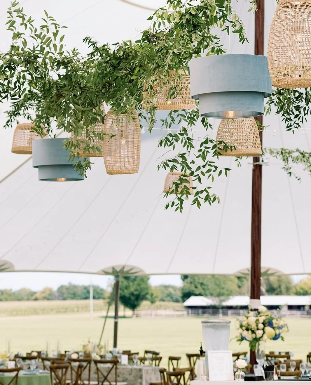 Blue pendants, natural rattan, and a sailcloth tent! Mixing textures and tones creates the perfect setting.⁠
⁠
Planning | ⁠@stylearchitectsweddings⁠
Venue | ⁠Twin Cities Polo Club⁠
Photography | @amandanippoldtphoto⁠
Catering | @forkandflairmn⁠
Bar |