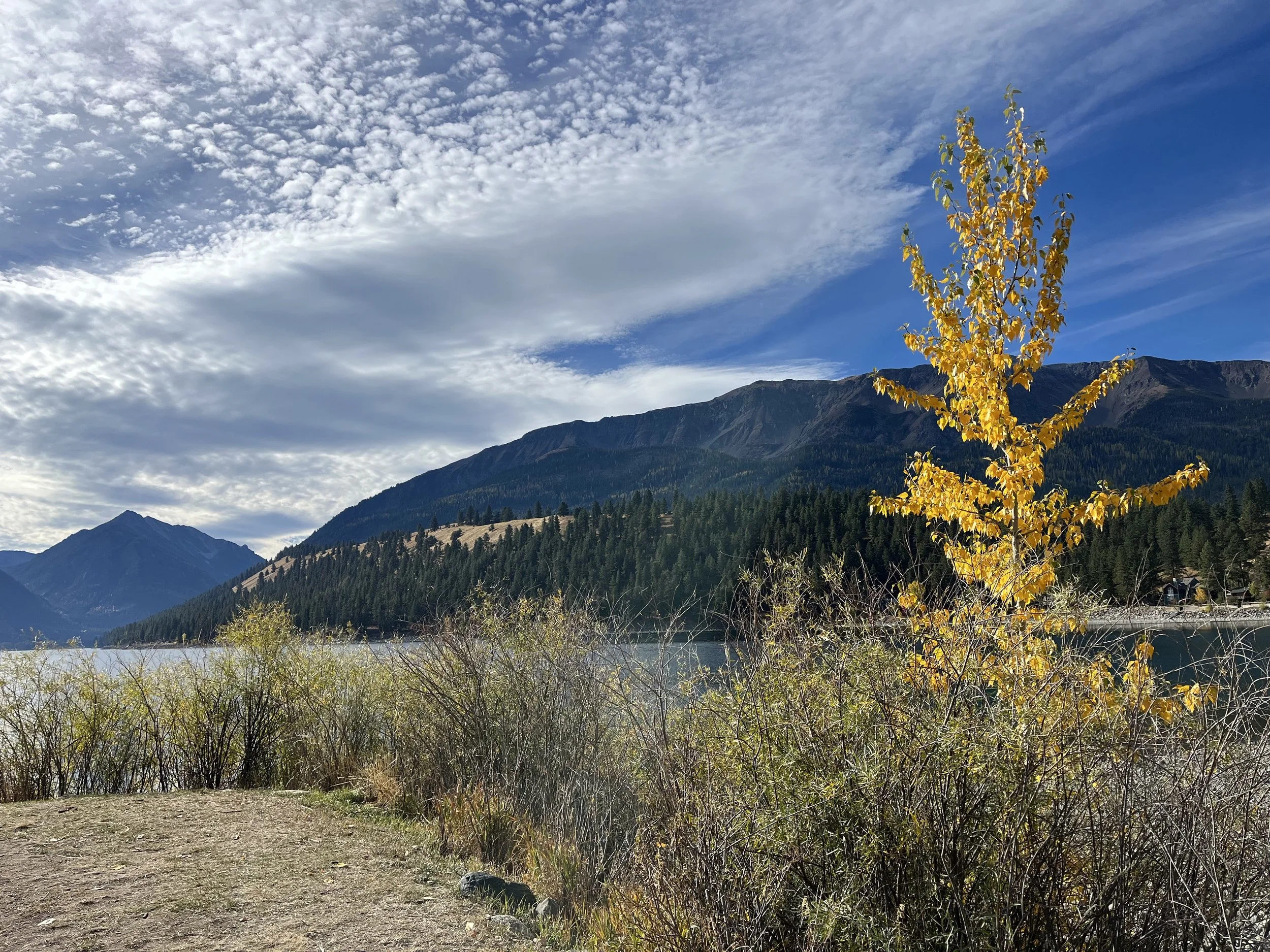 River winding through a mountain valley, reflecting life's journey and spiritual growth.