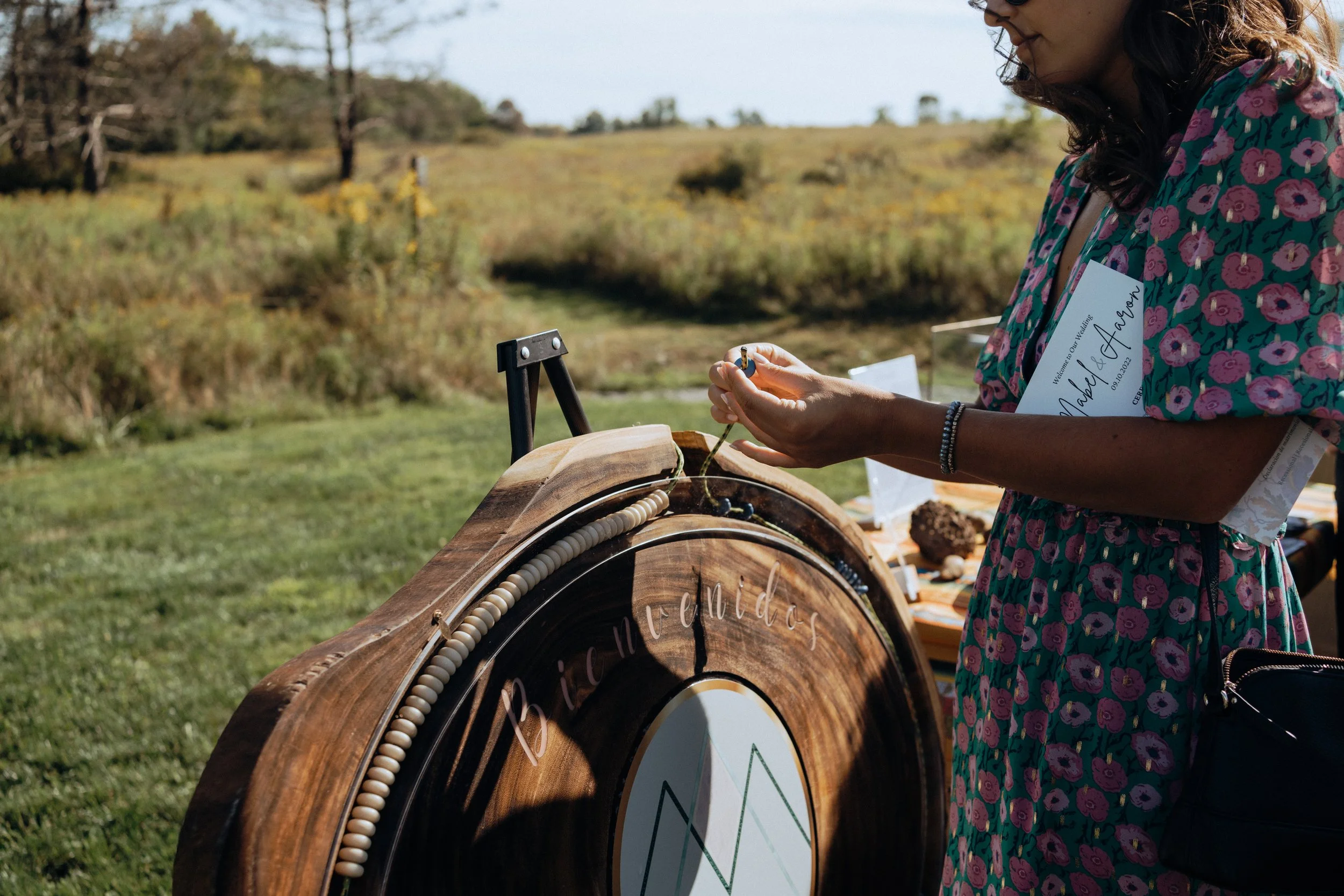 An Image of a woman adding a bead to the ceremonial lasso