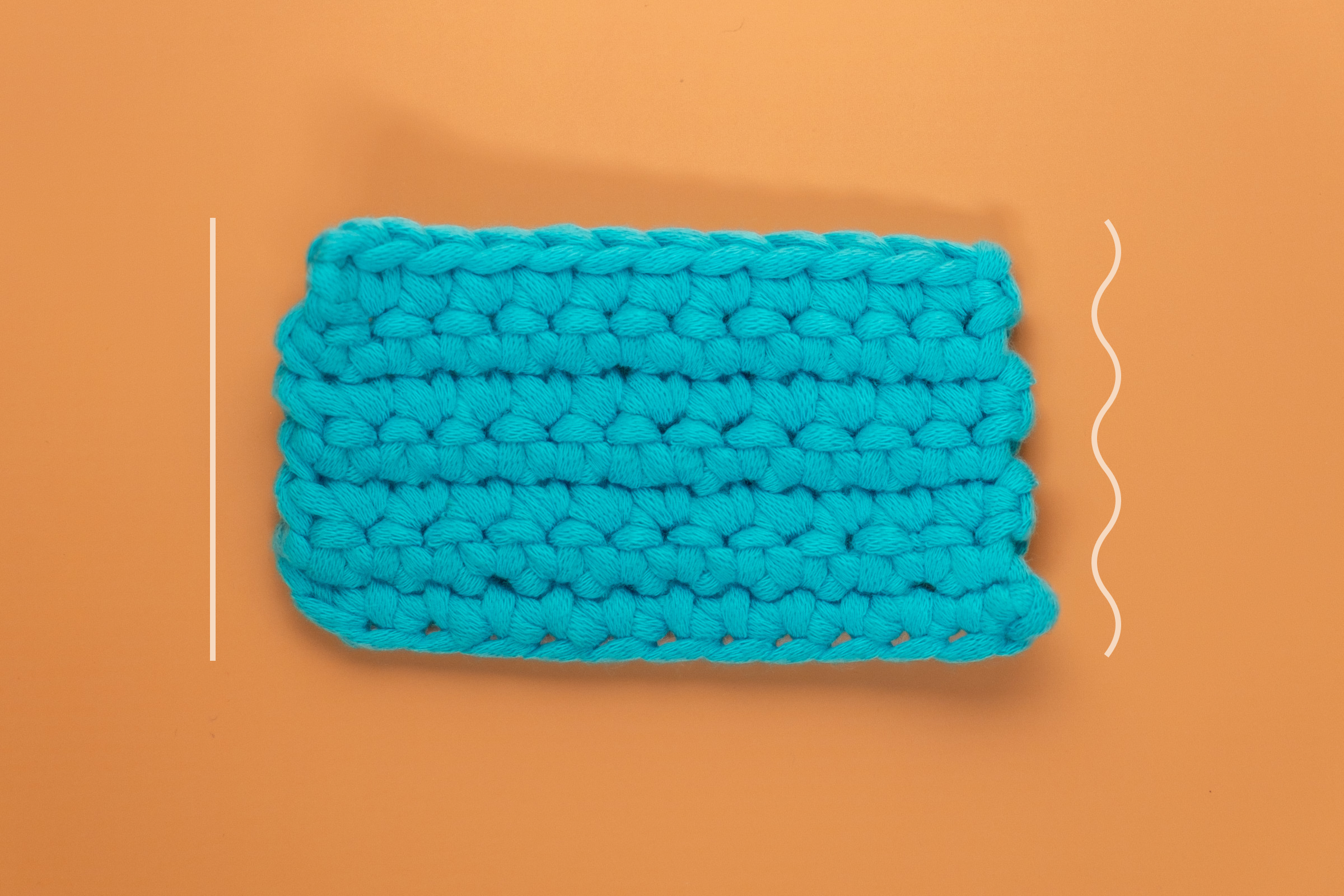 A swatch of single crochets in rows with a straight left side and a wavy right side