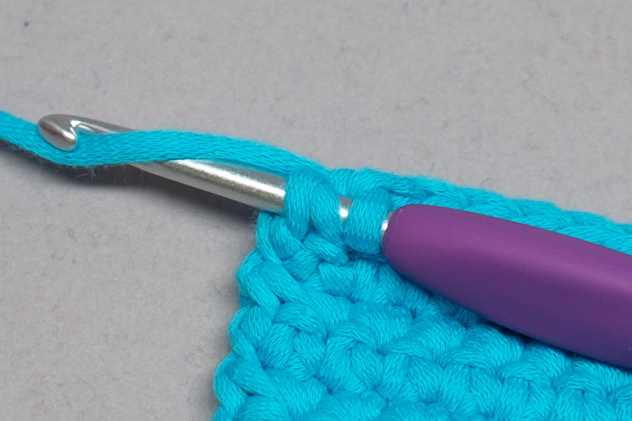  With the three loops on your hook, yarn over, pull through two loops. Complete your sc and continue. 