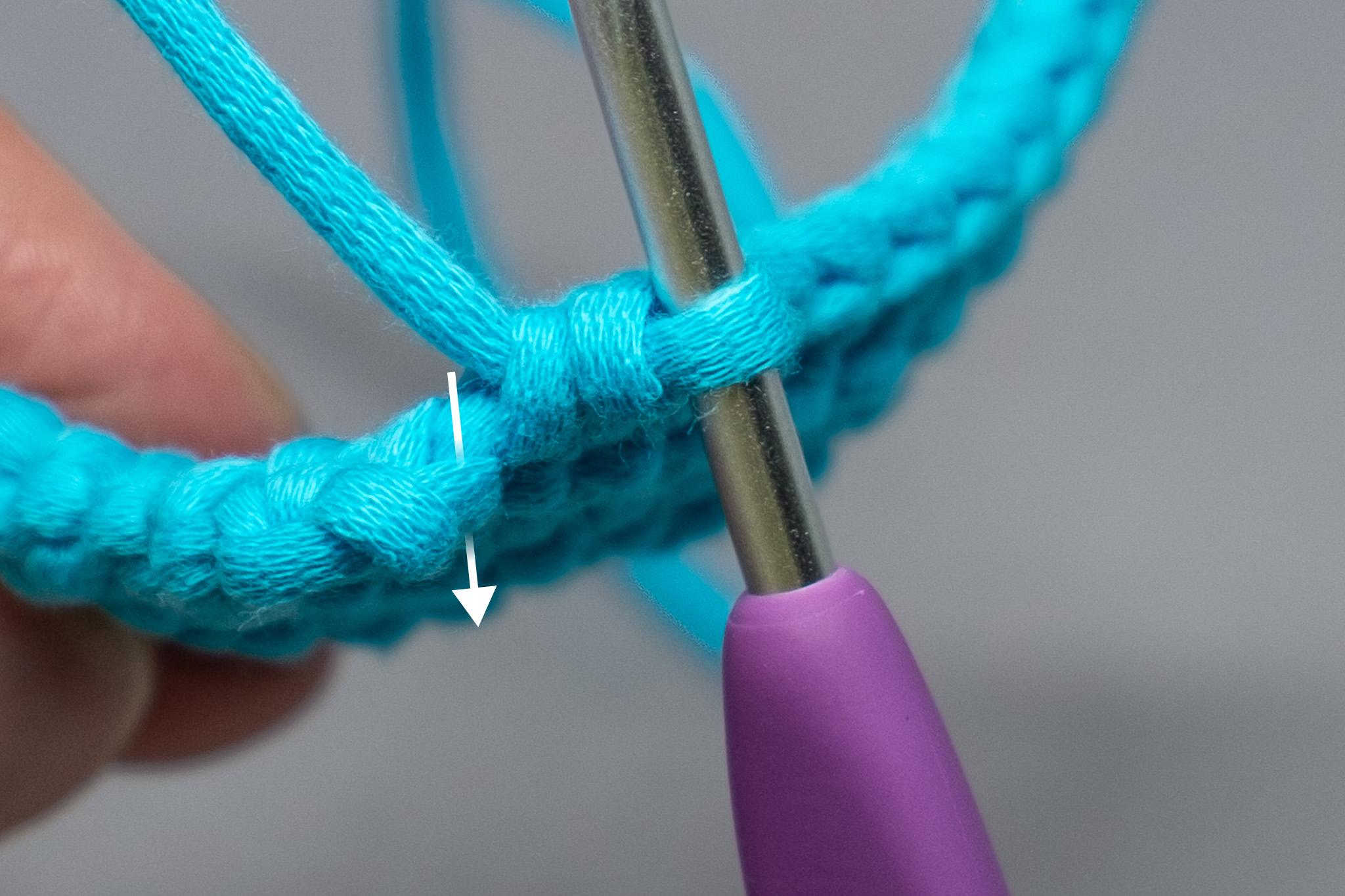  Find the "V" on the top of the last stitch from the previous round and insert your hook through the center of it. 