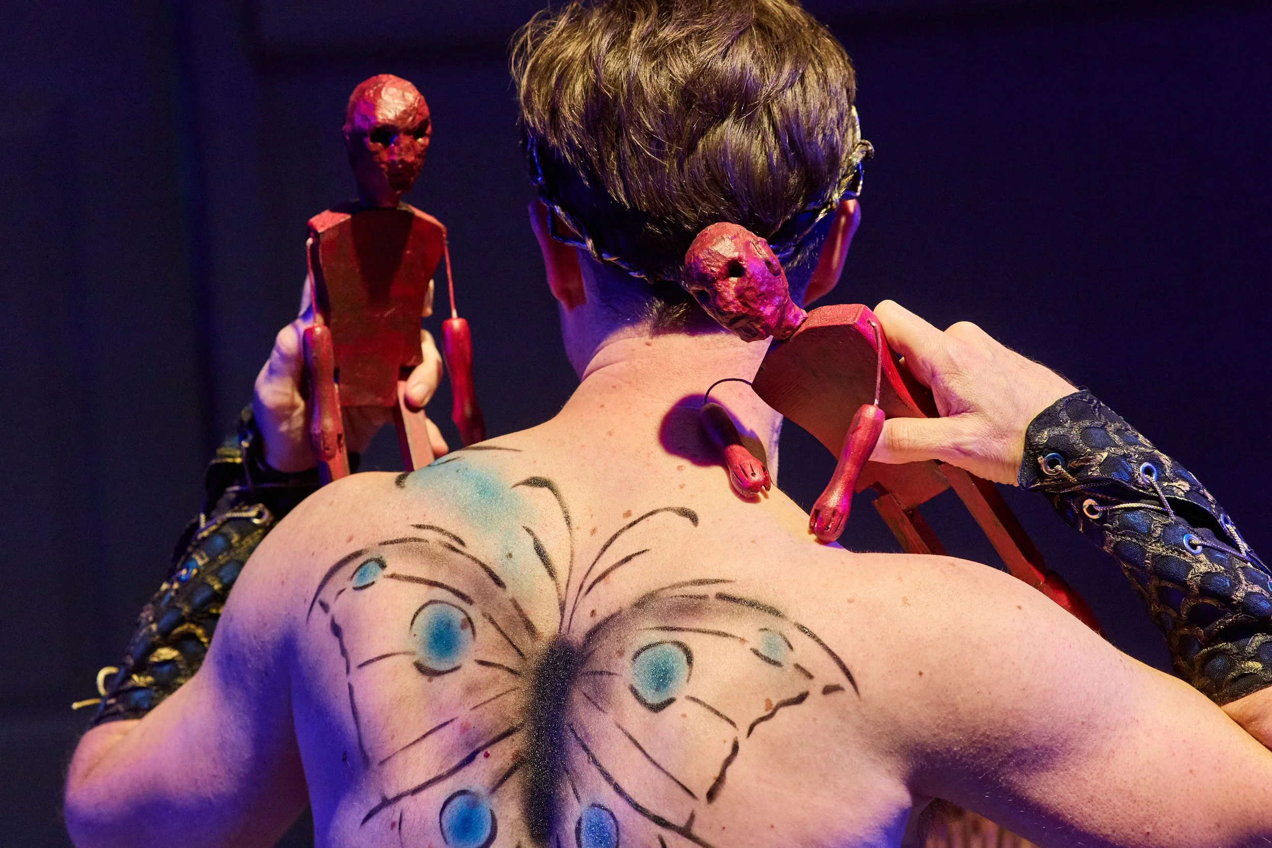 Image of man holding puppets