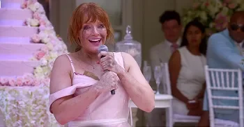 Lacie clutching a microphone while giving an erratic speech during a mental breakdown