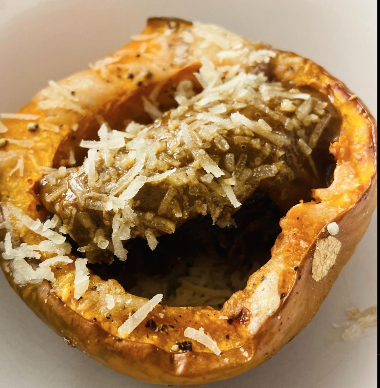 Baked stuffed bell pepper with cheese and rice filling.