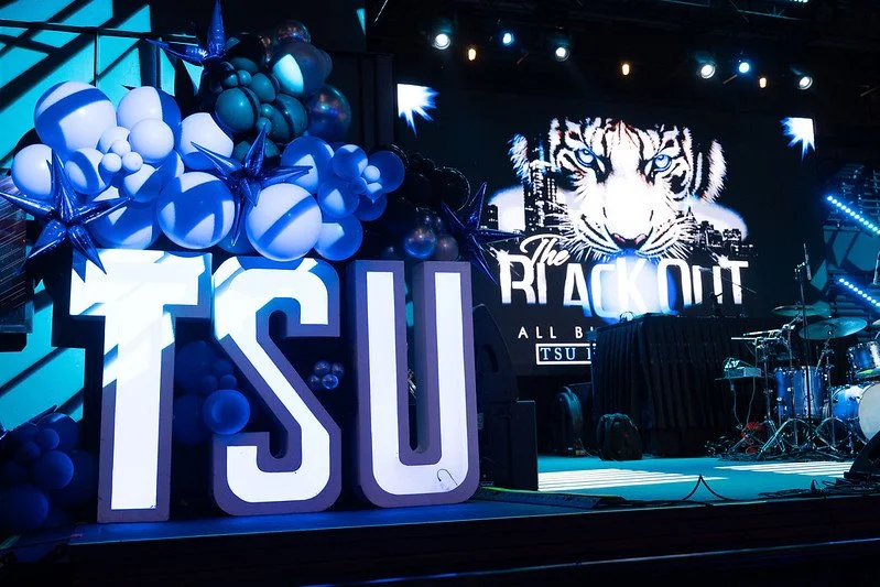 Stage decorated with balloons, large TSU letters, and a screen displaying a tiger and the words "The Knockout"
