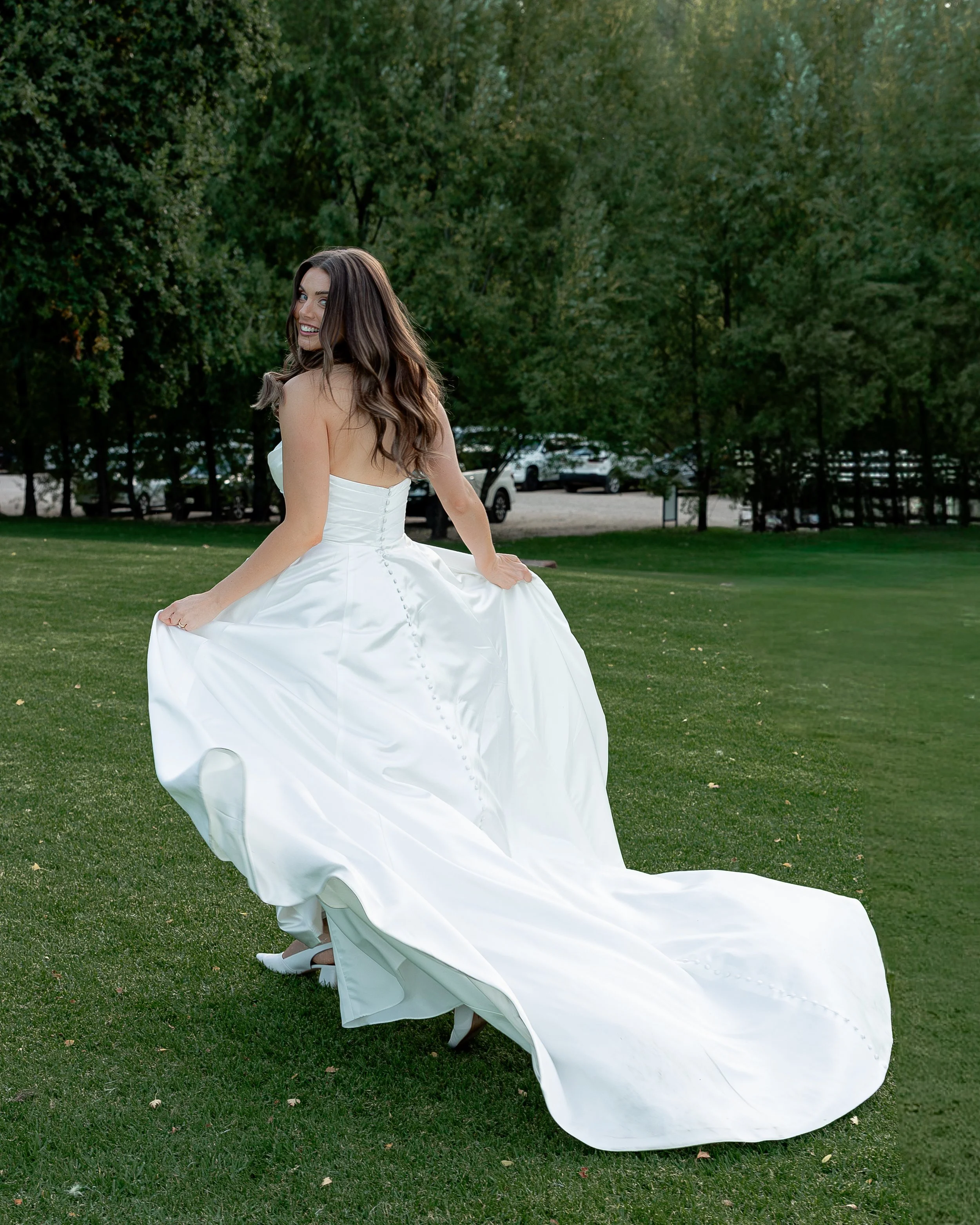 Bride walking on the grass in her wedding gown during relaxed outdoor wedding portraits in South Australia.
