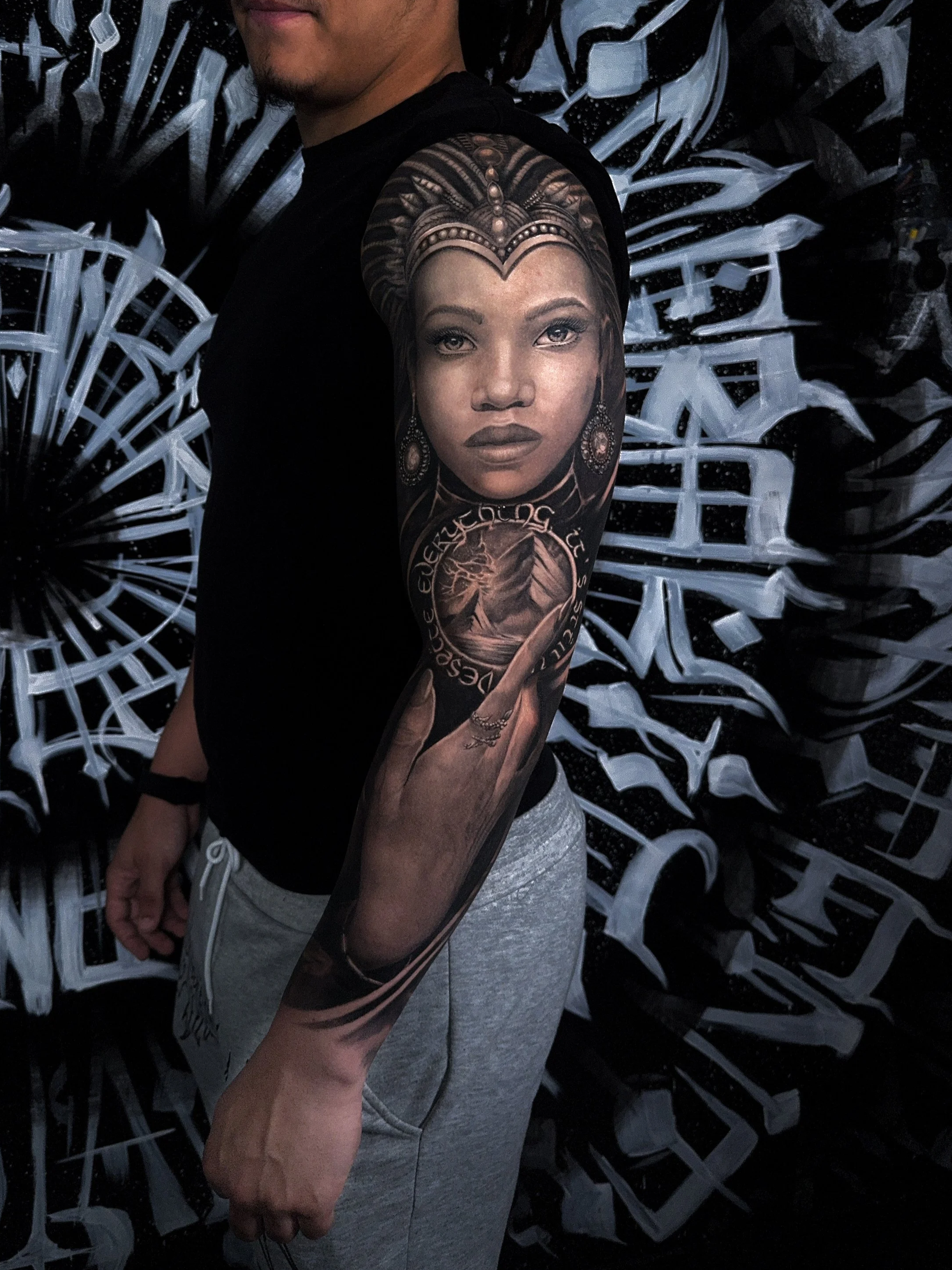 Portrait Tattoo in Black and Grey mit weiblichem Gesicht, ornamentalem Kopfschmuck und realistischer Schattierung.