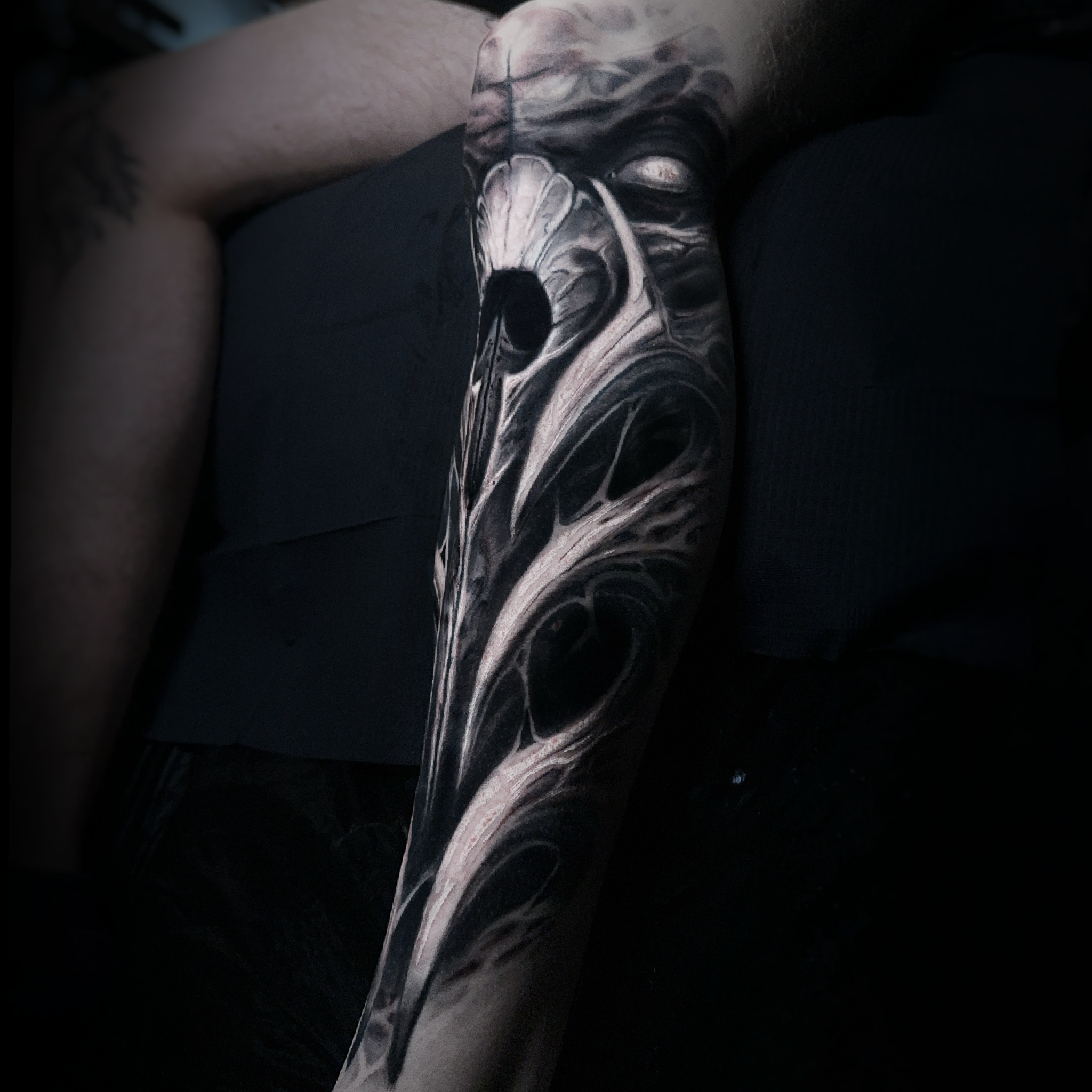 Dark style lower leg shin tattoo