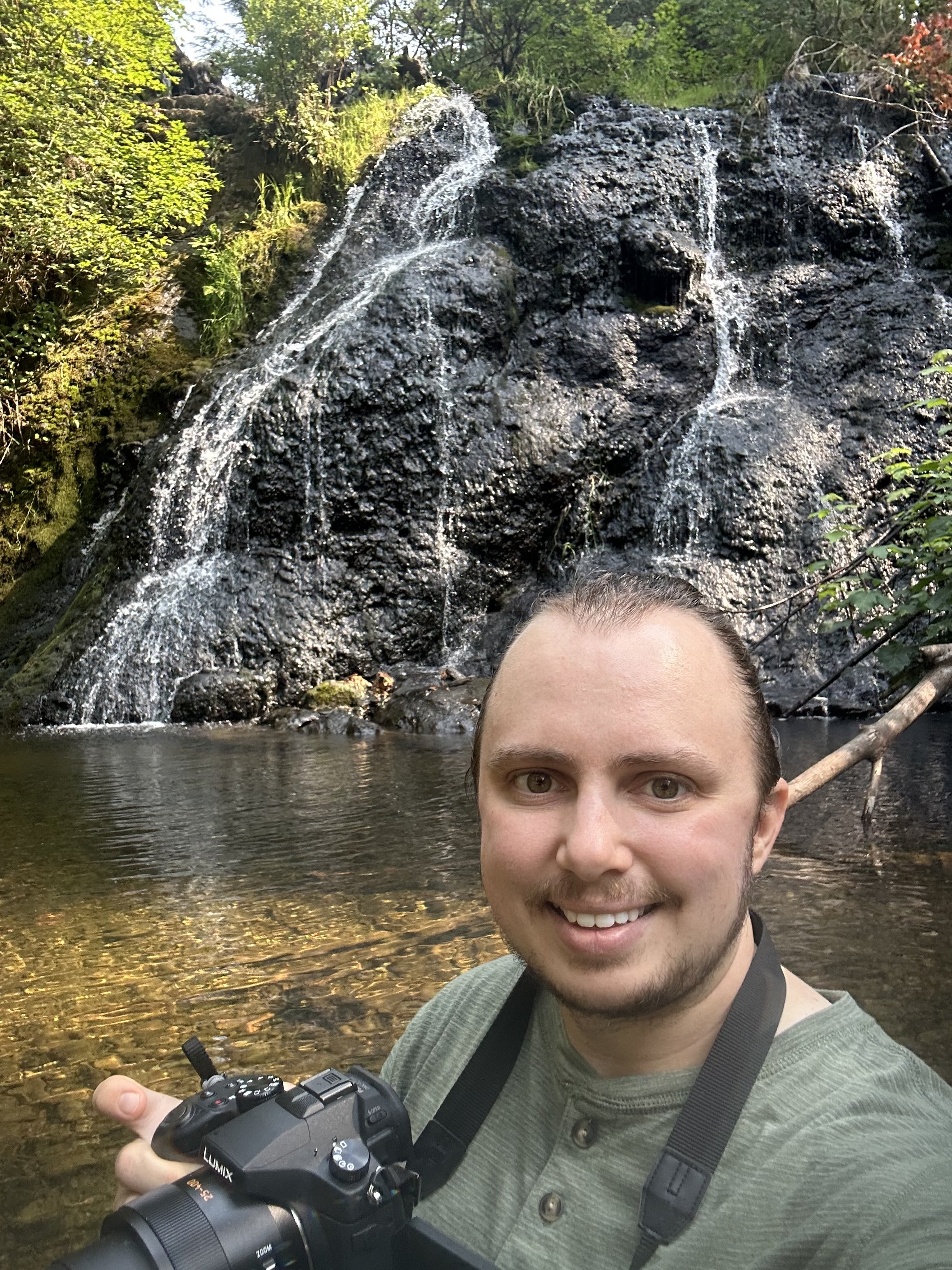 Standing in front of a waterfall with my camera.