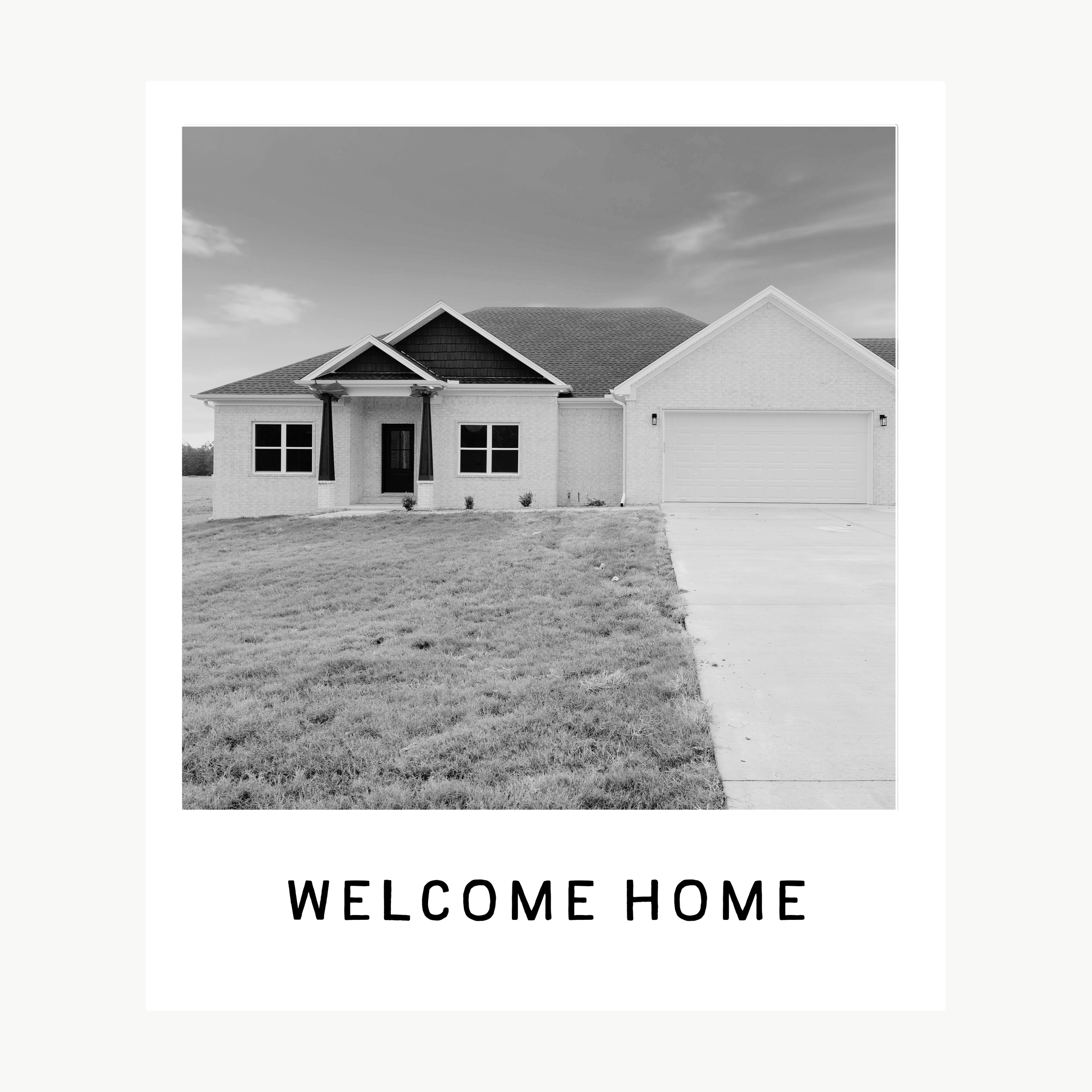 A black-and-white greeting card with a photo of a single-story house with a front lawn, driveway, and garage, and the text "WELCOME HOME" below the photo.