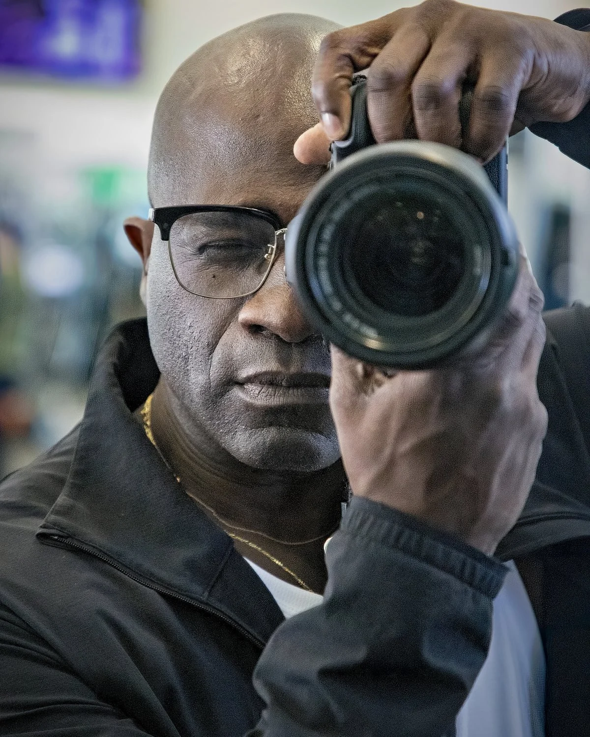 Gregory Willard, Los Angeles event and portrait photographer, holding a Canon camera to his eye