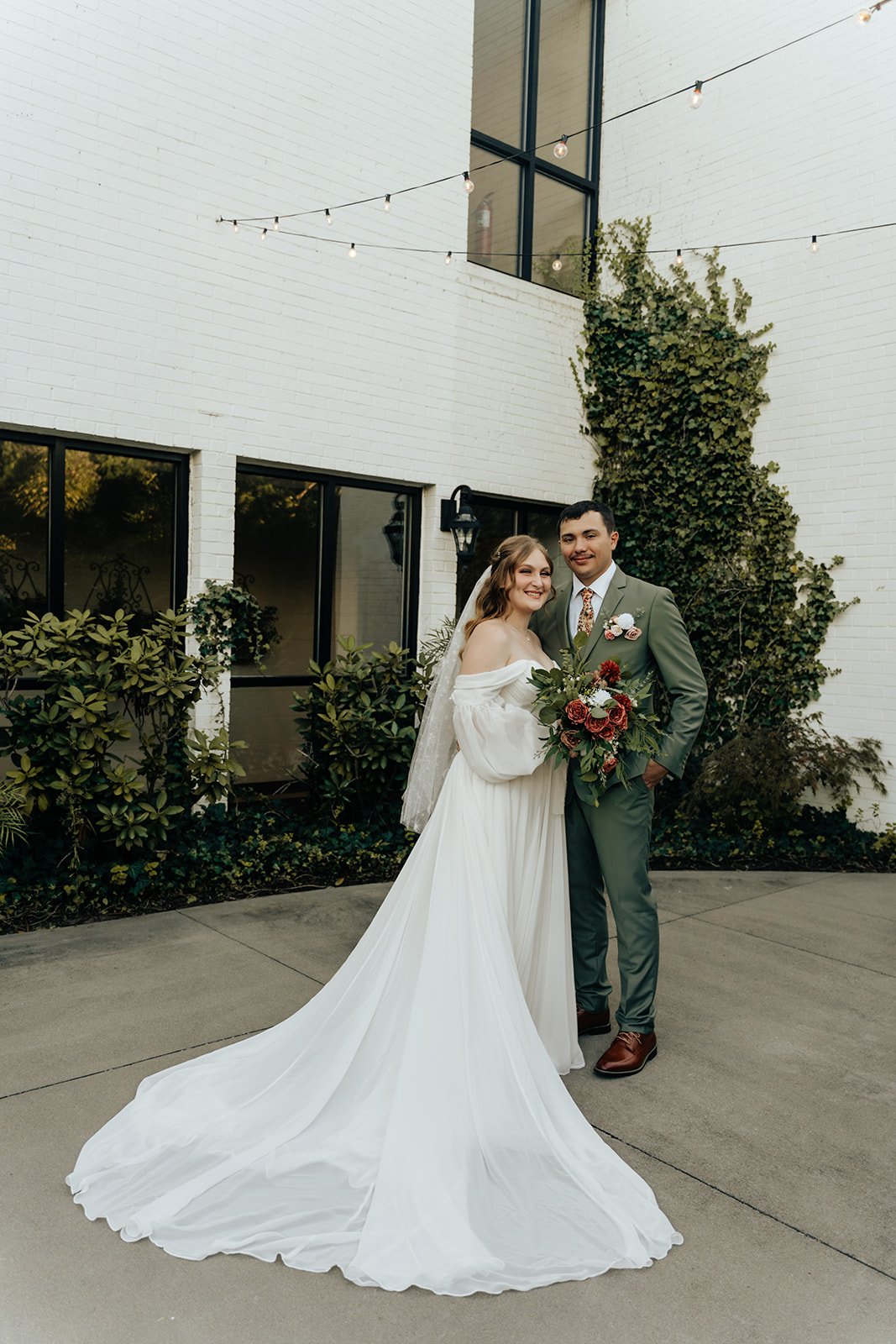 Flock of Canada geese swimming on a pond with a water fountain and trees in the background.
