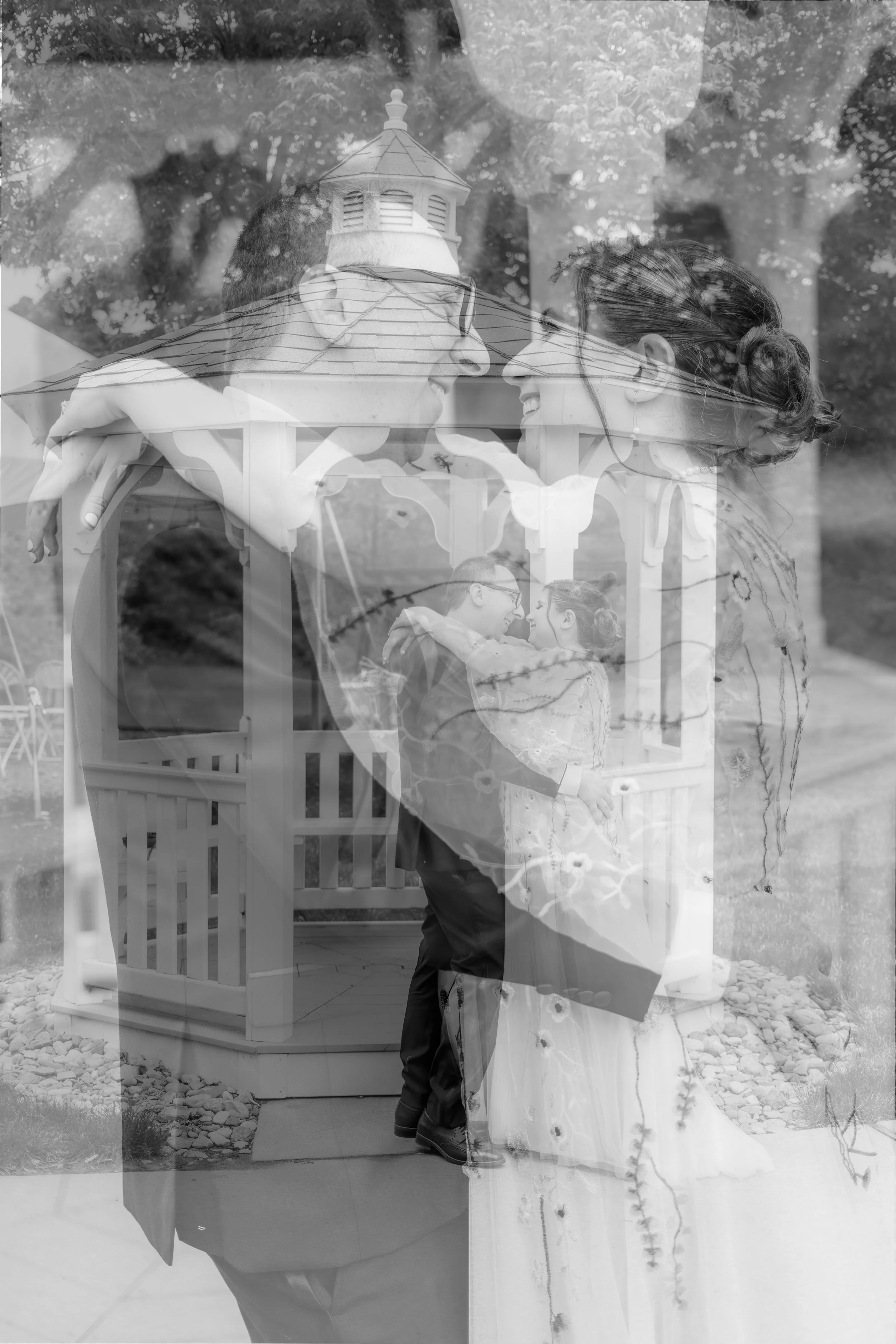A double exposure photo of a man and a woman smiling at each other, with a small gazebo and trees in the background.