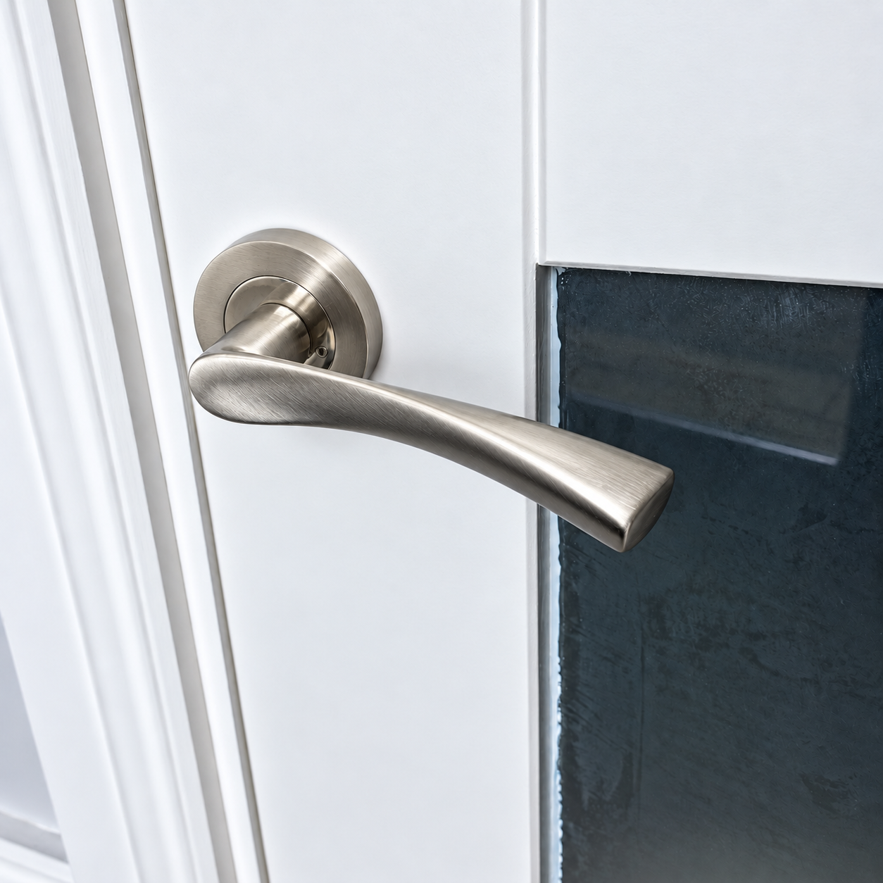 Satin nickel lever on white glass door.png