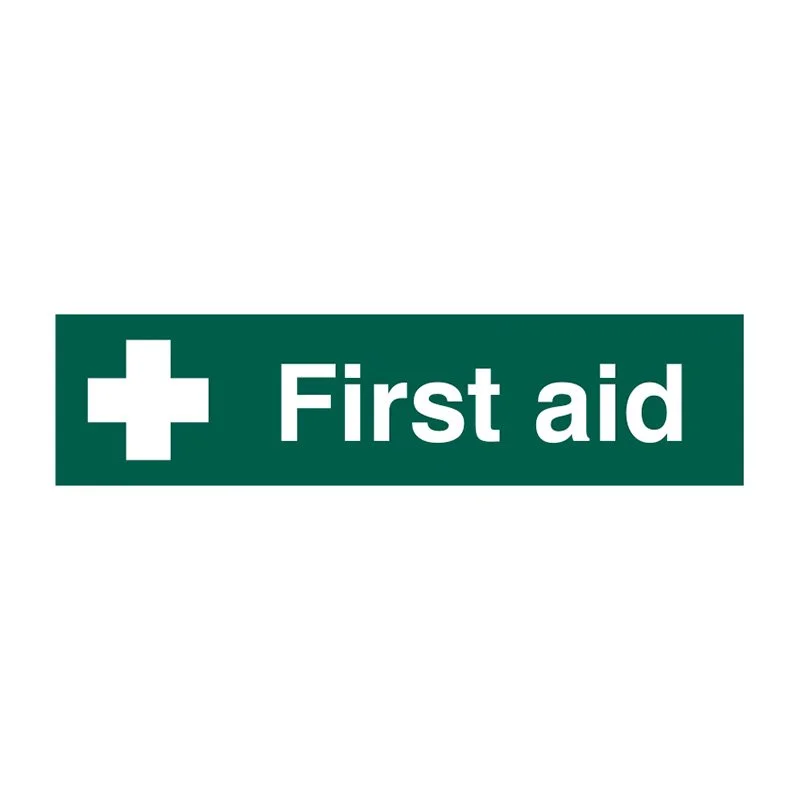 Green rectangular sign with white cross and the text "First aid"