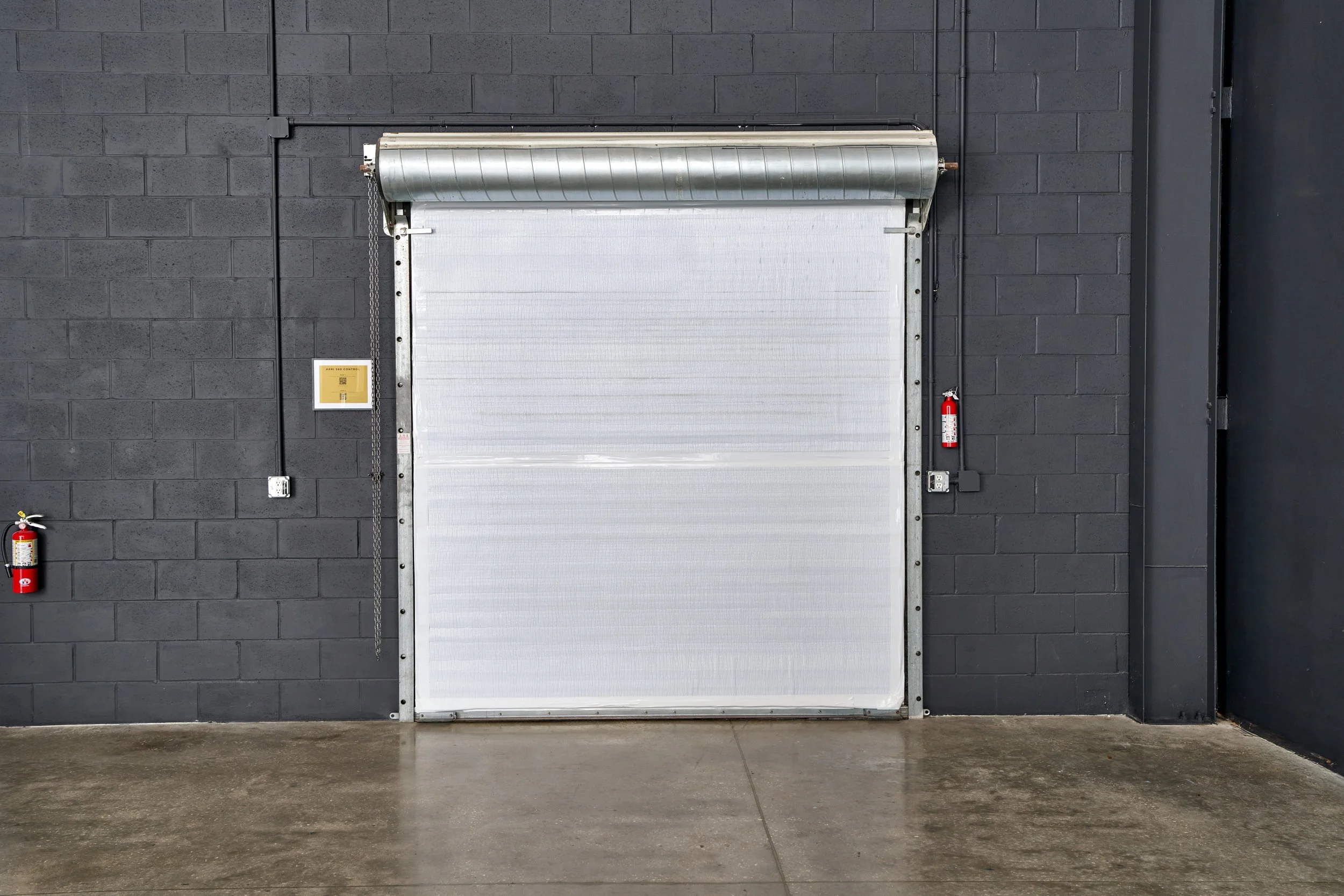 Large industrial roll-up loading door at Go Bold Studio in Casselberry, FL, providing convenient drive-in access for commercial video and photography equipment in the Orlando area.