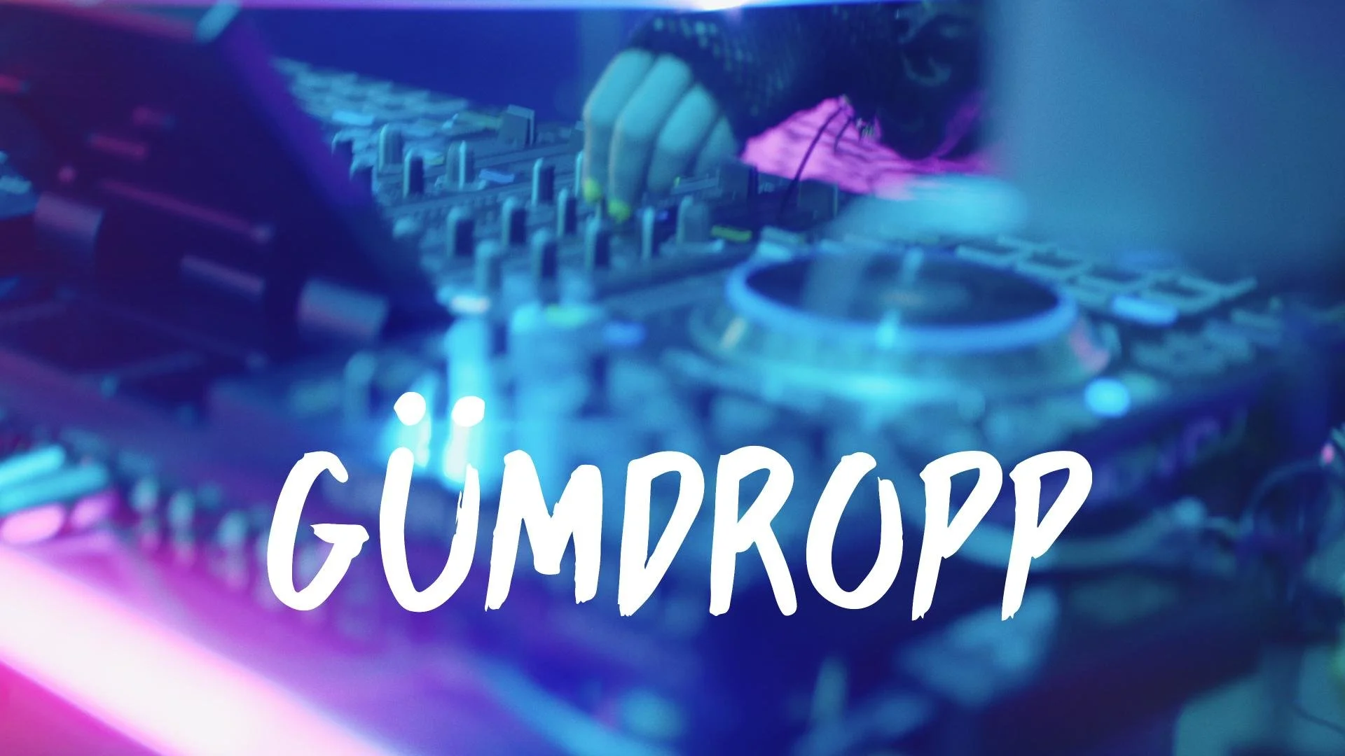 Close-up of DJ equipment with colorful neon lighting and the word 'GUMDROP' written in white text over the bottom portion of the image.