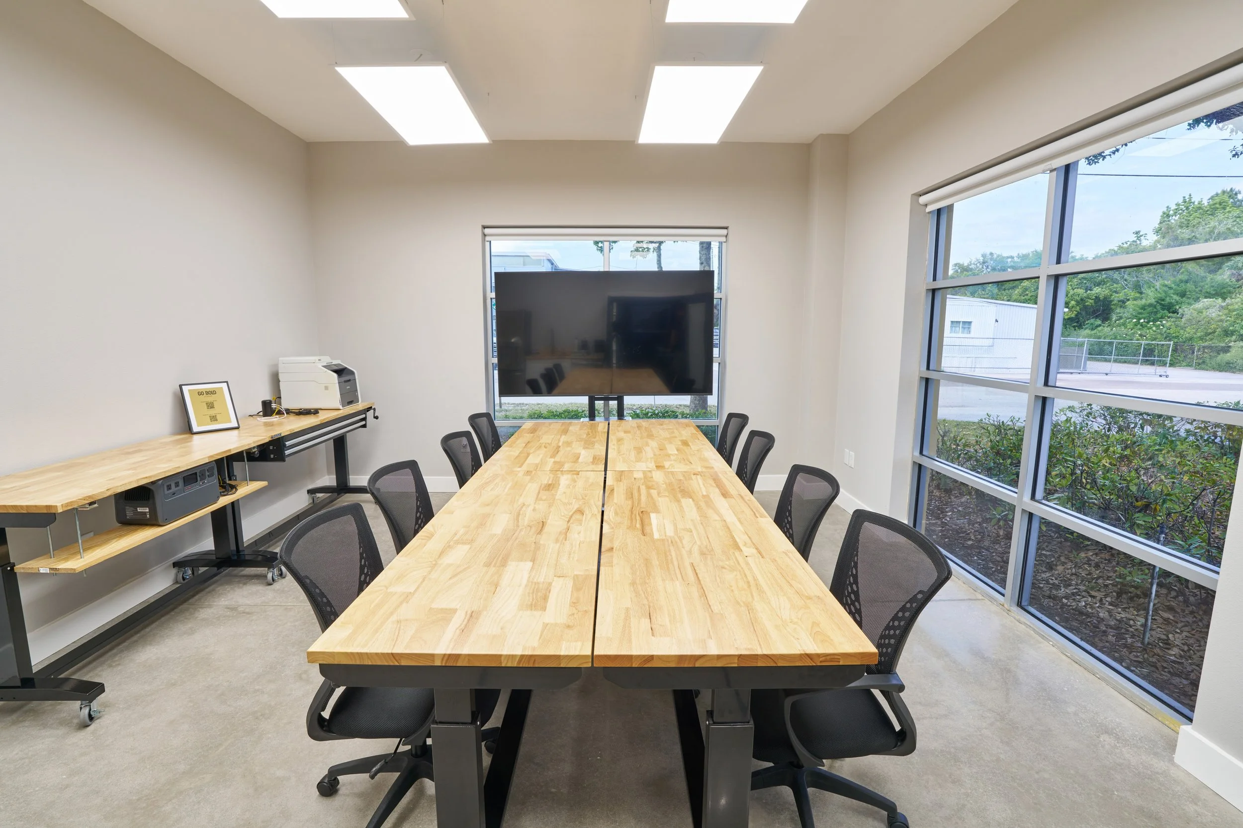 Modern conference room and production meeting space with large screen monitor at Go Bold Studio in Casselberry, FL, ideal for Orlando commercial production teams.