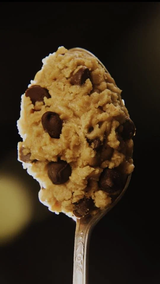 A spoonful of cookie dough with chocolate chips.