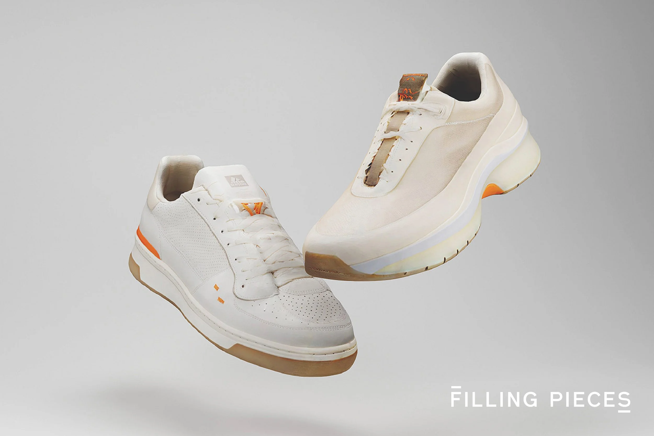 Two white sneakers with orange accents floating against a gray background, with the words "FILLING PIECES" in the bottom right corner.