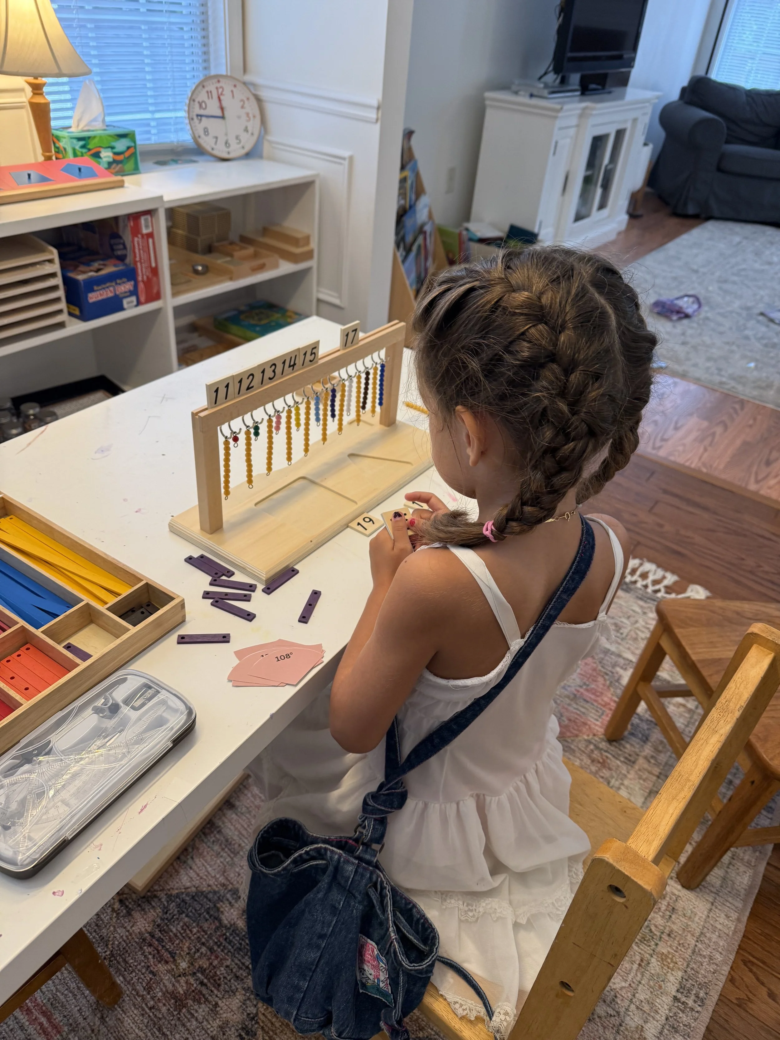 Montessori kindergartener works with math beads for teens and numeracy