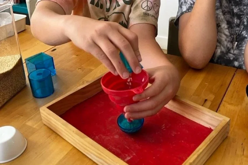 Montessori homeschool children work with geometric shapes and volume in a math lesson
