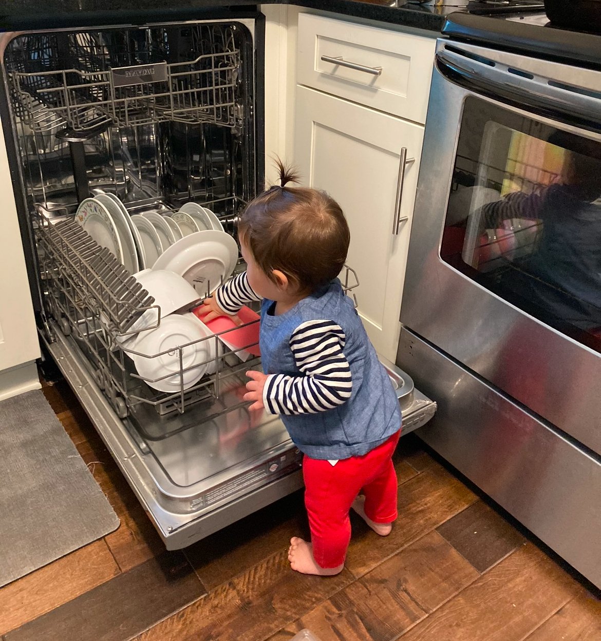Montessori toddler loads the dishes at home practical life activity