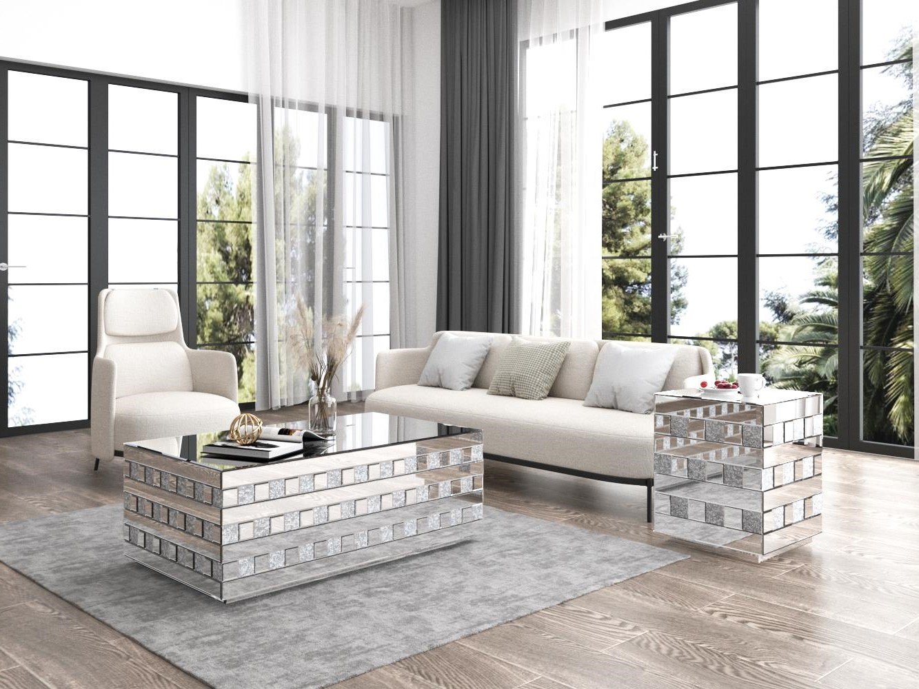 Modern living room with large windows, a white sofa, an armchair, a silver tiled coffee table, side table, and decor items including a vase and tray with fruit.