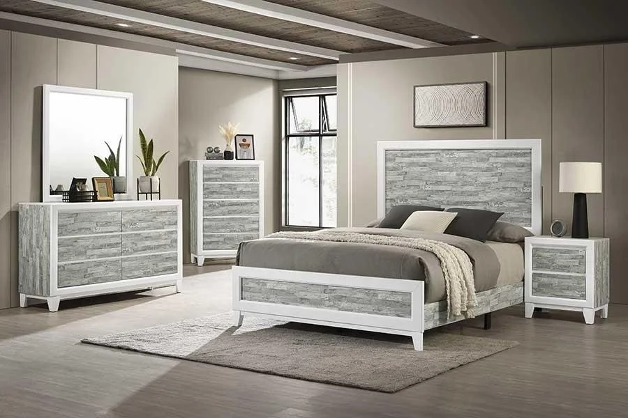 Modern bedroom with a white and gray color scheme, featuring a bed with a wood-paneled headboard, matching nightstand, dresser, and chest of drawers, with a large mirror and minimal decor.
