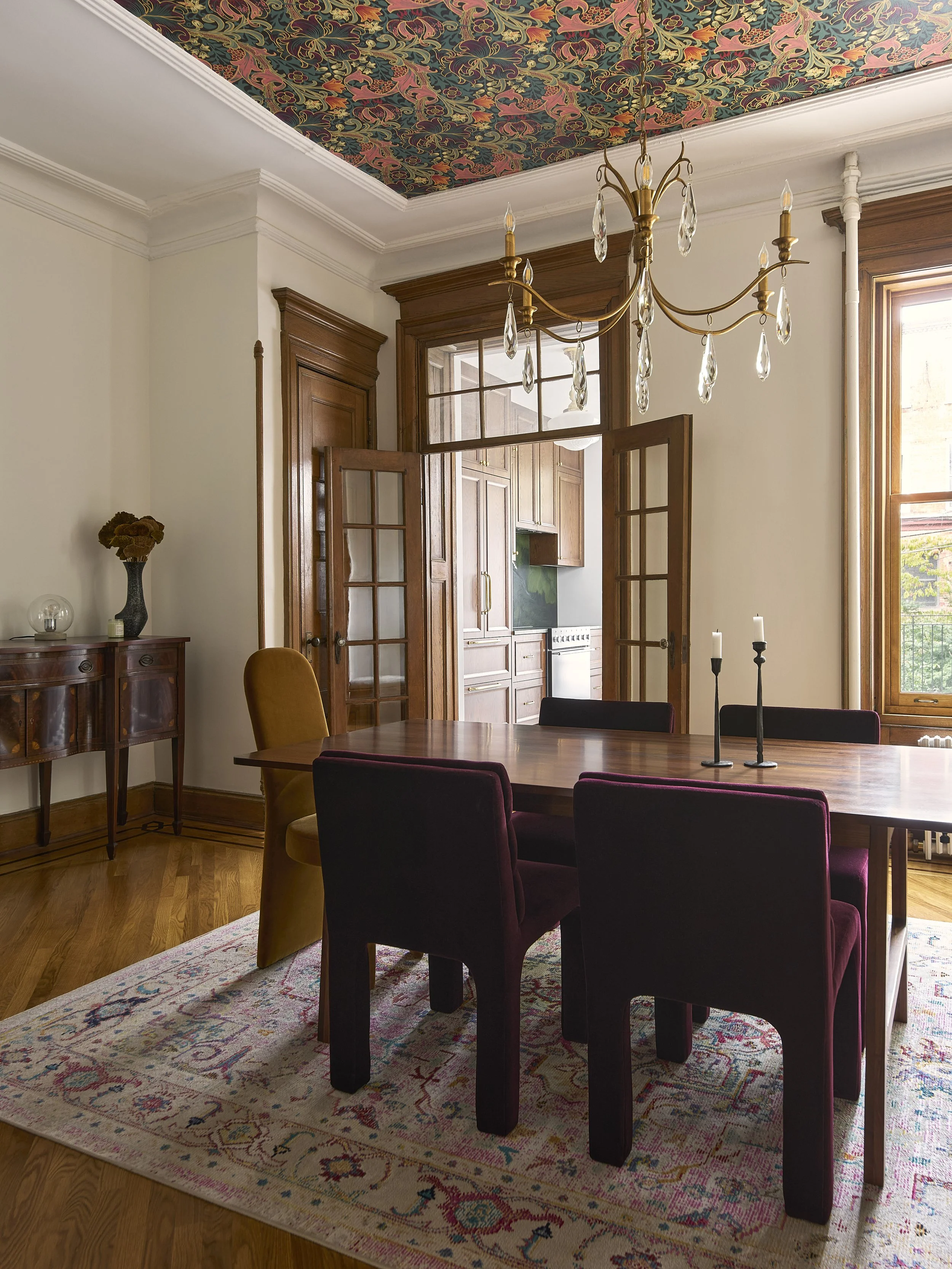 restored dining room with wallpaper detail on ceiling